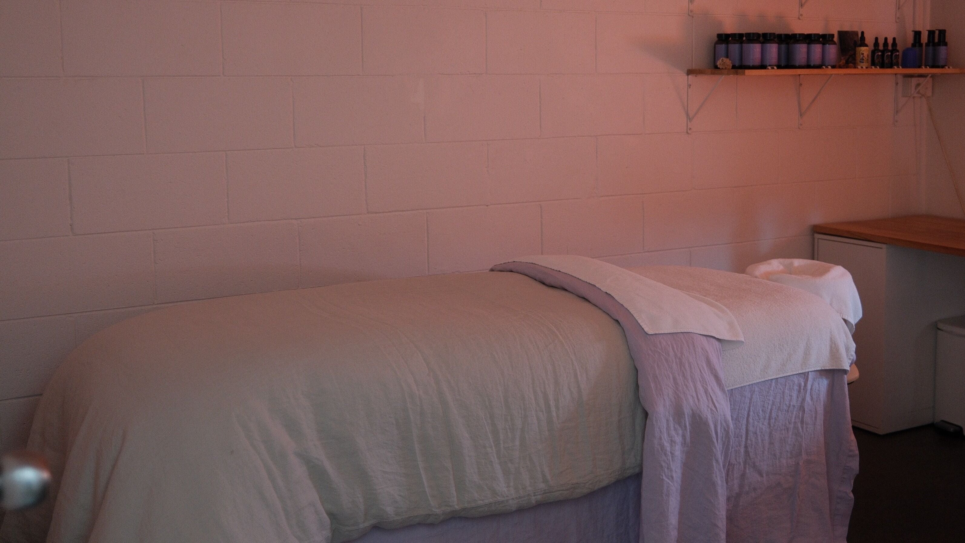 Tranquil massage room at Soften ADELAIDE, Hyde Park, South Australia, AU, with cozy linens and calming decor.
