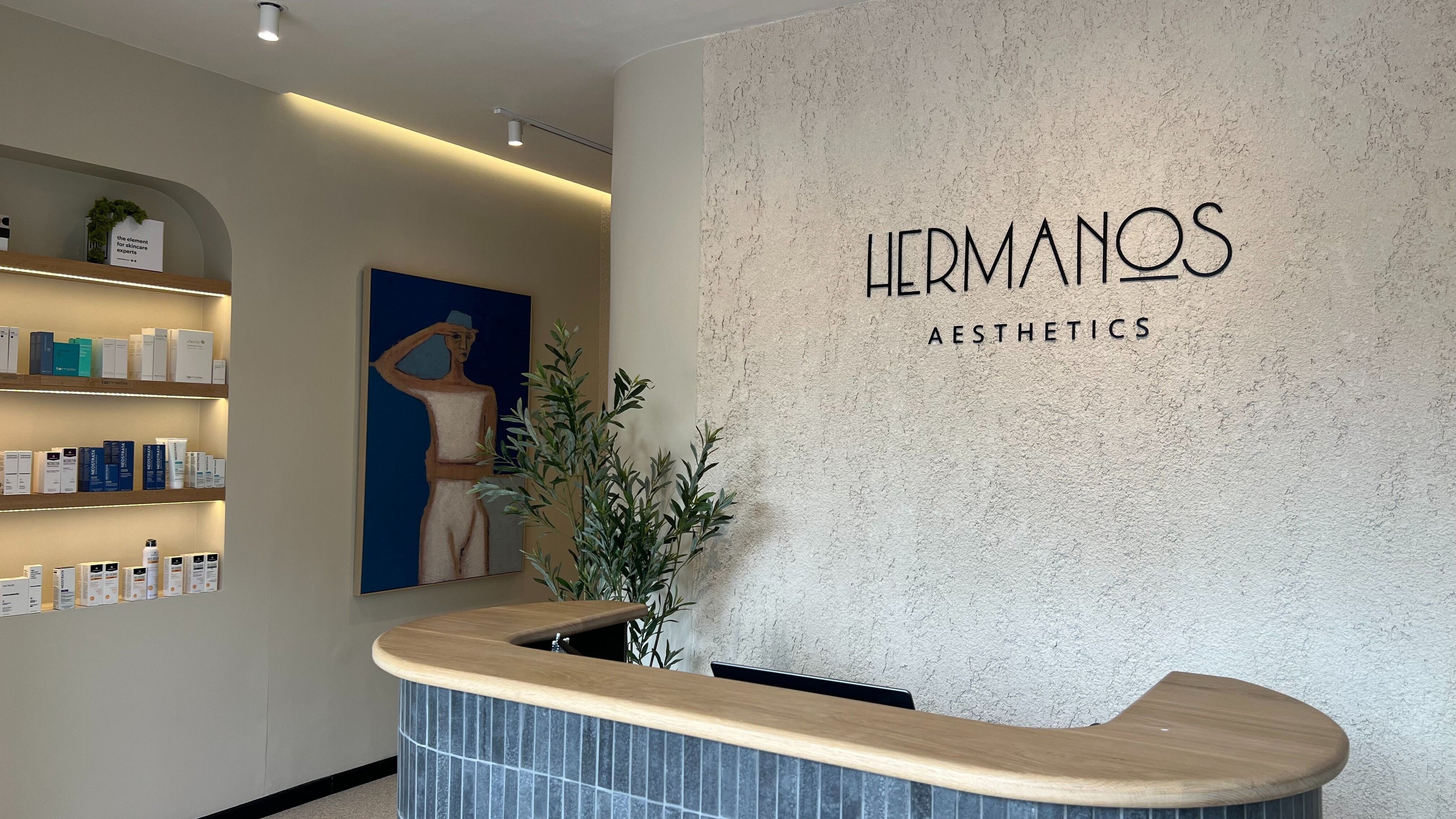 Reception area at Hermanos Aesthetics, Cape Town, Western Cape, ZA with modern decor and skincare products.