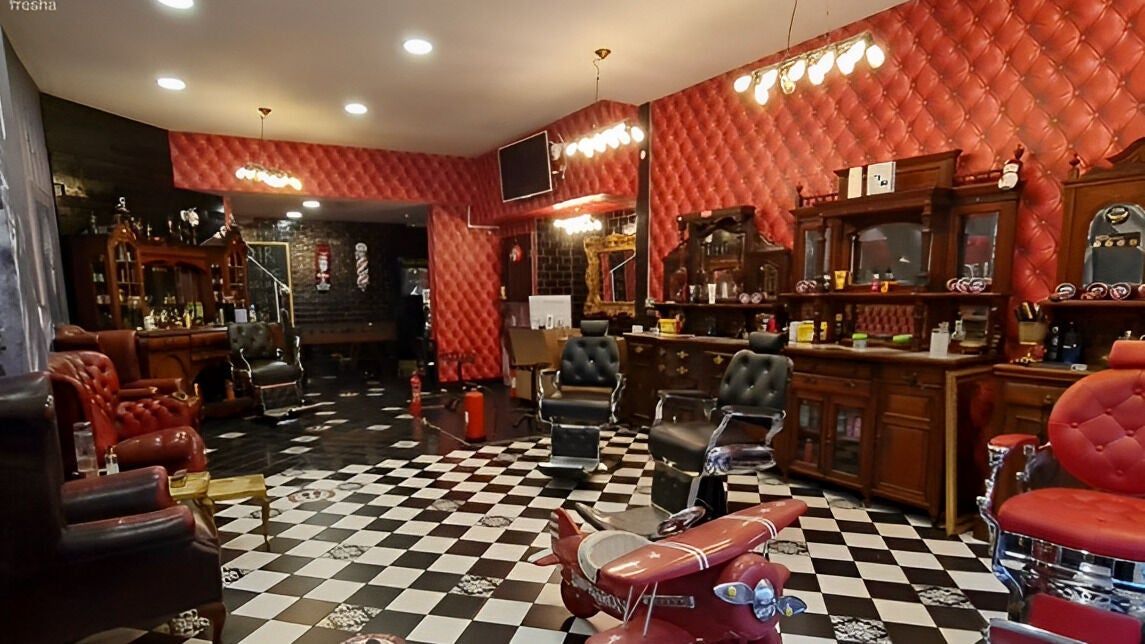 Chic vintage interior of Brazuca B5 Barbers in Carlisle, England, GB, featuring plush chairs and classic decor.