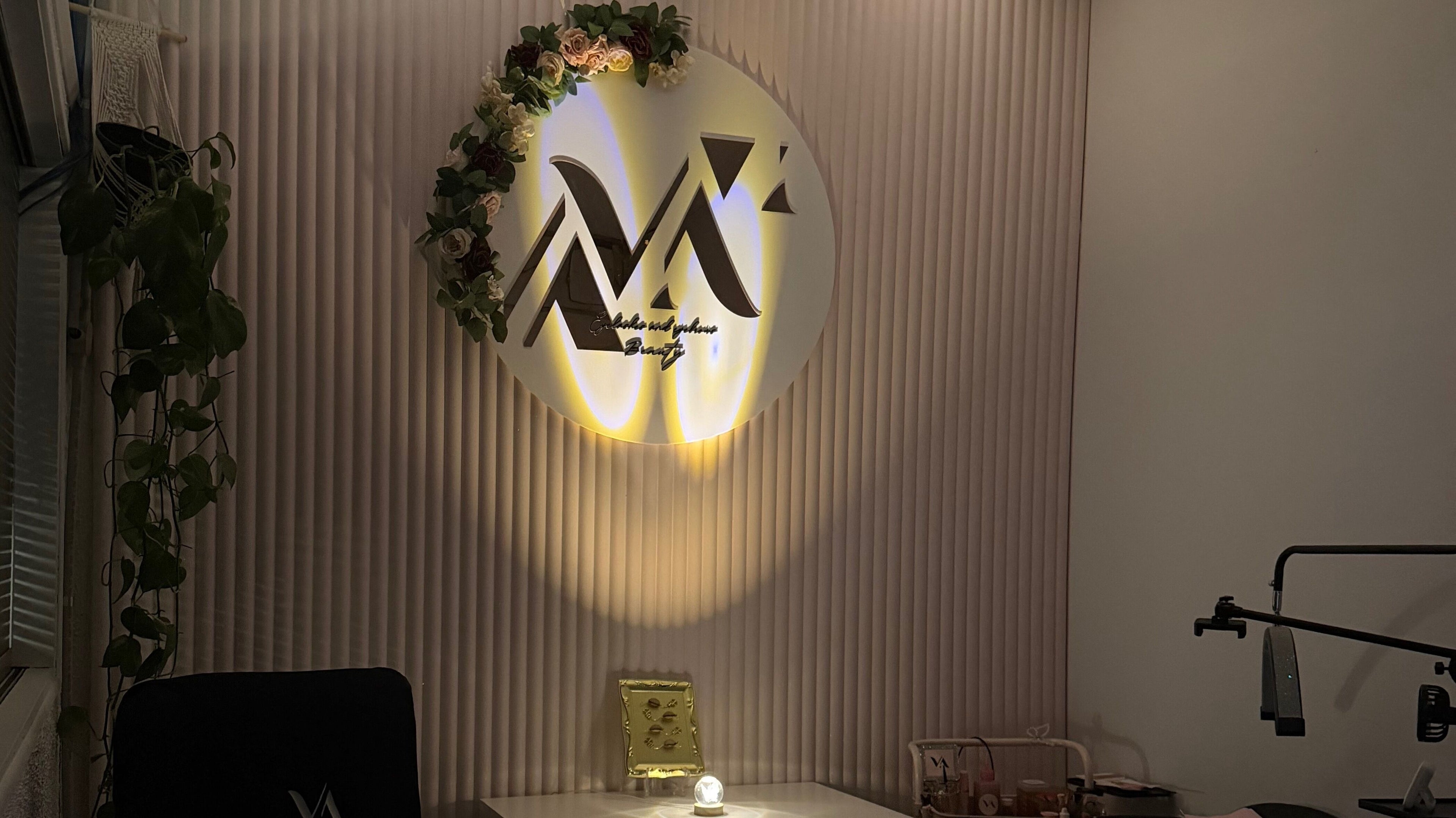 Interior view of VA Eyelashes & Eyebrows in Sydney, New South Wales, AU, featuring branded decor and ambient lighting.