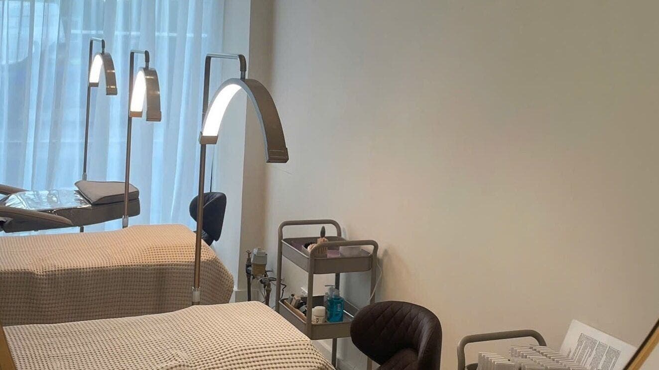 Treatment beds at The Oasis Cosmetic Tattoo Malvern in Melbourne, Victoria, AU with lamps and equipment.