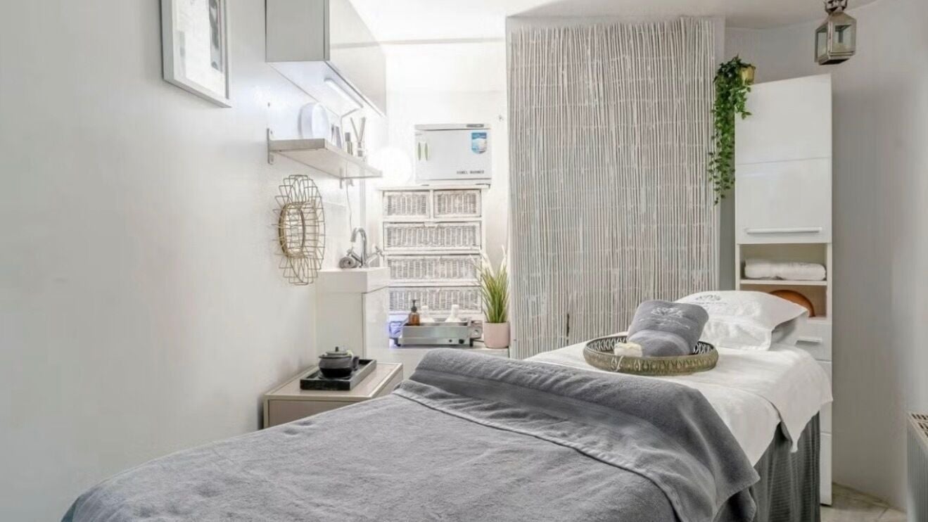 Tranquil treatment room at Wellness Skin & Laser Centre, London, England, GB with soft lighting and cozy bed.