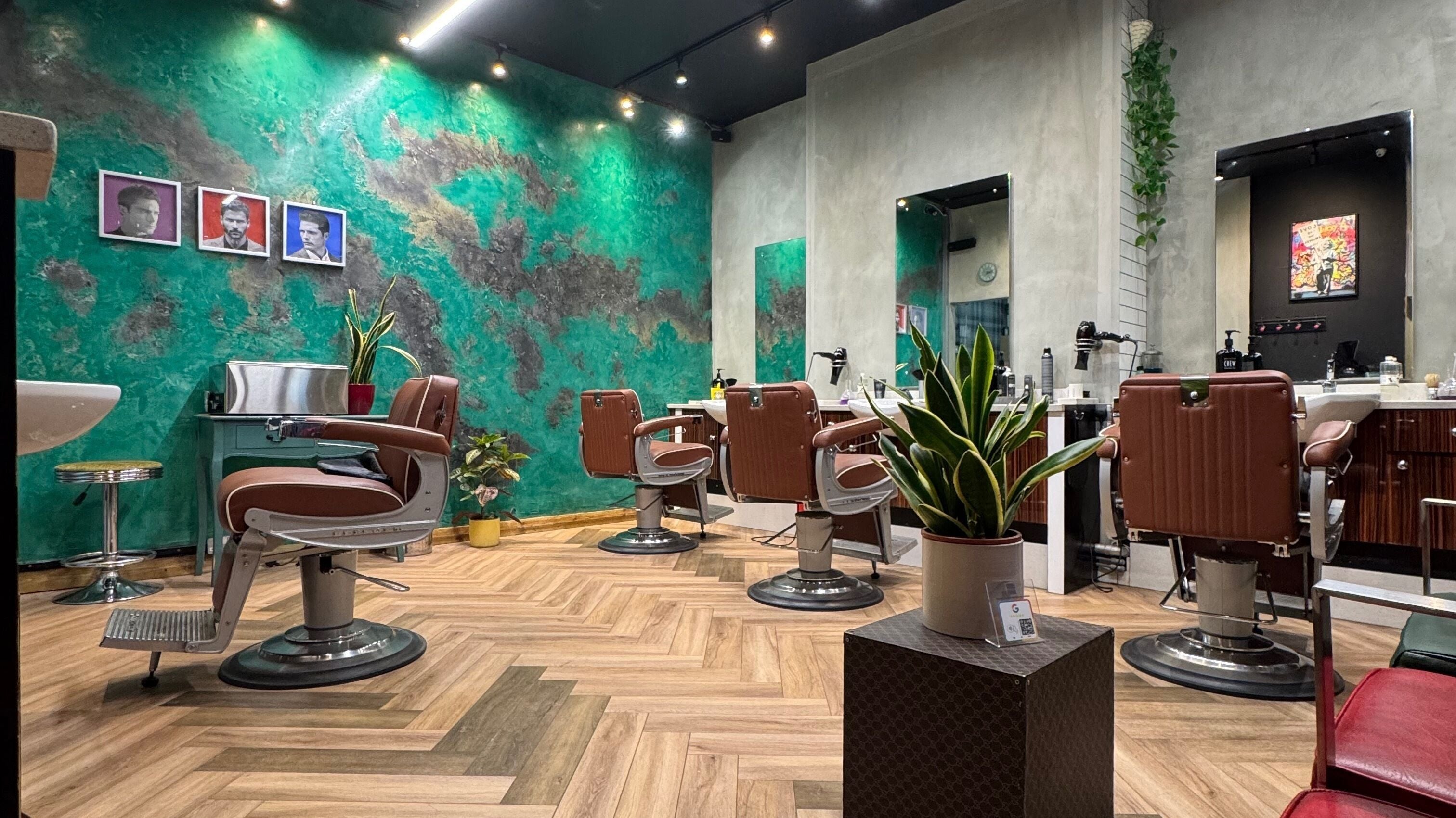 Chic interior of Midtown Barbers | Hairform For Men, London, England, GB, with modern chairs and vibrant decor.