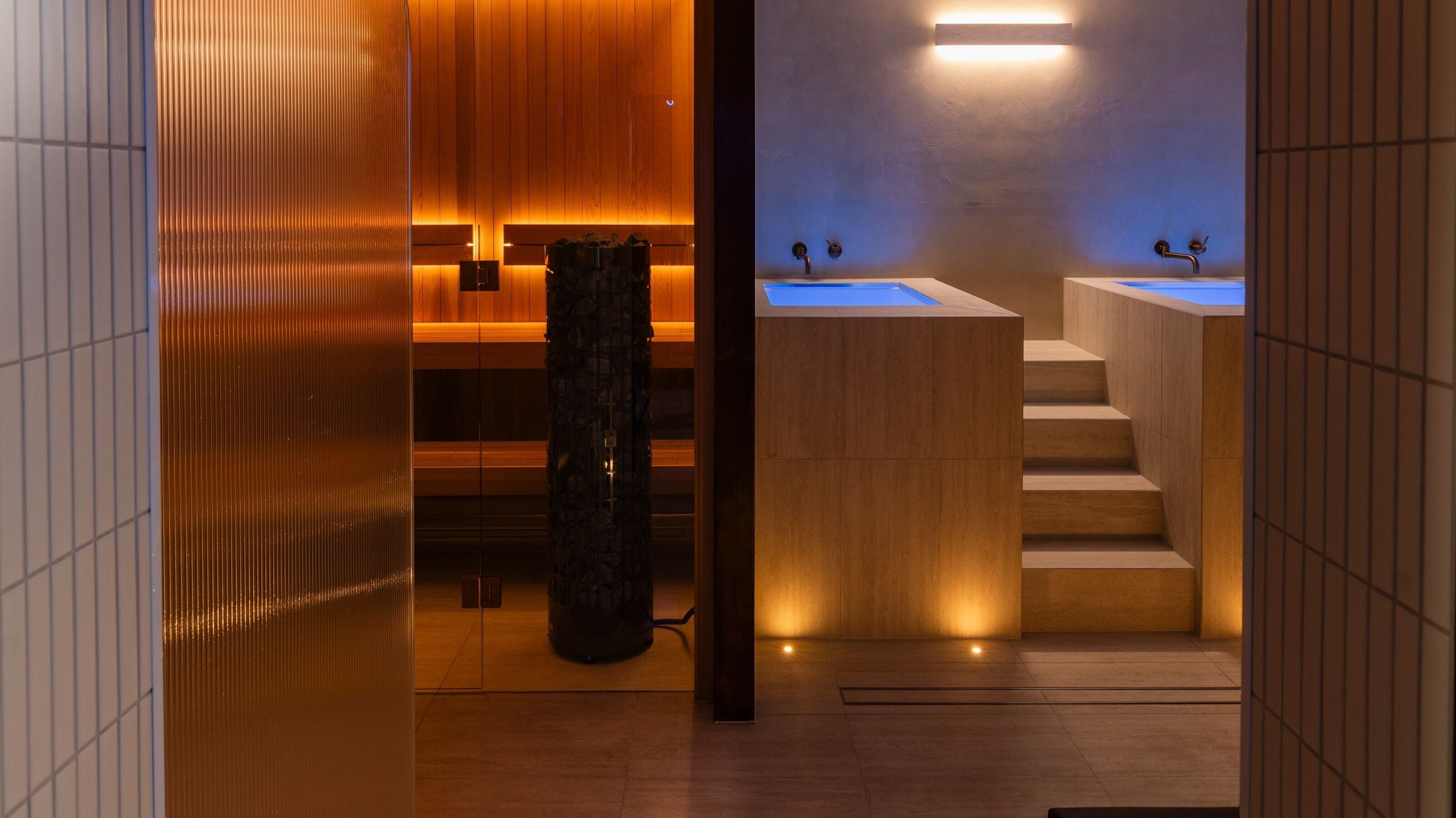 Luxurious spa room at My Recovery Lounge, Port Melbourne Beach, Victoria, AU, featuring warm lighting and hot tubs.
