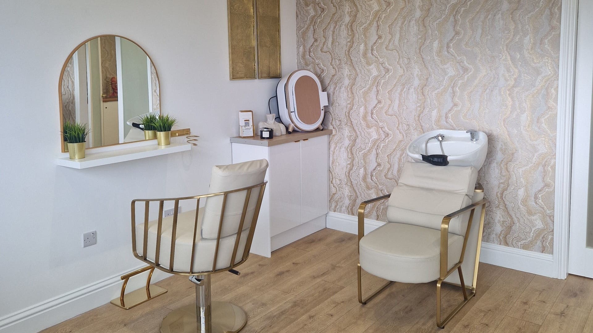 Modern salon interior at The Beauty of Aesthetics, Romford, England, GB, featuring chic decor and styling chair.