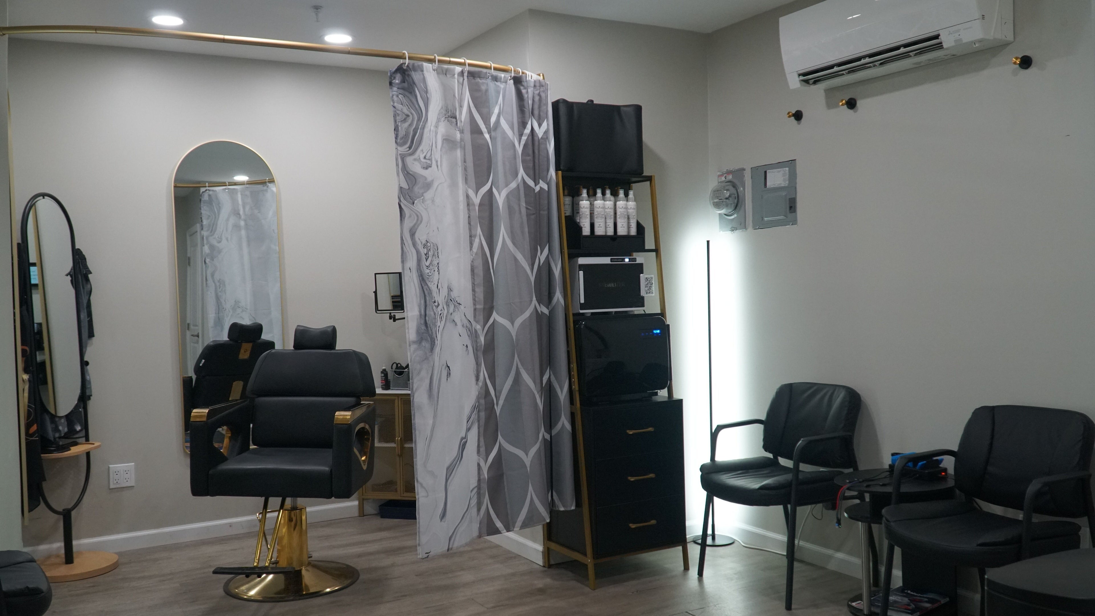 Yoffi salon interior in Monroe, New York, US; features sleek black chairs and modern decor.