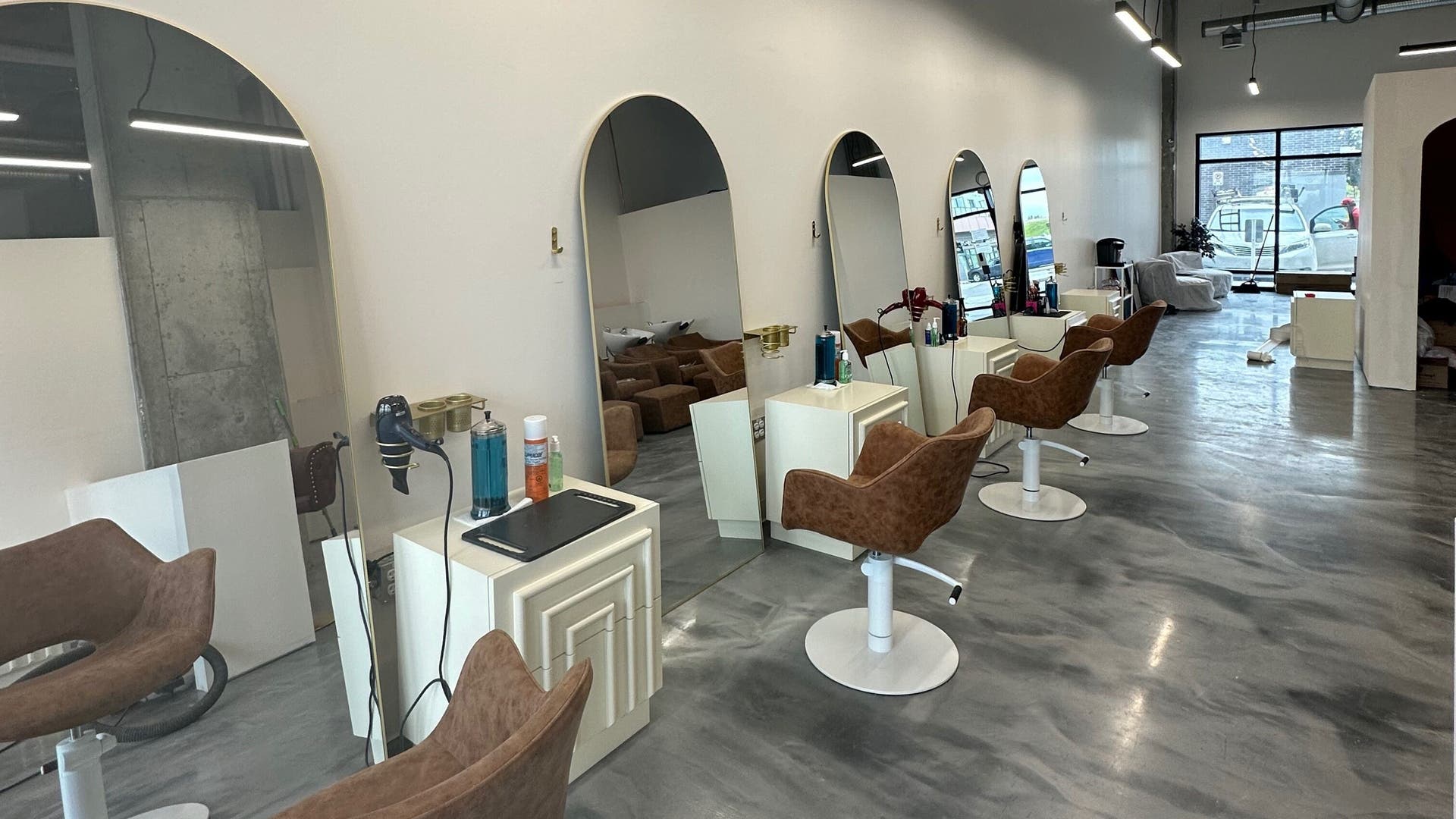 Modern salon chairs and mirrors at AIO Hair, Calgary, Alberta, CA, showcasing elegant salon design.