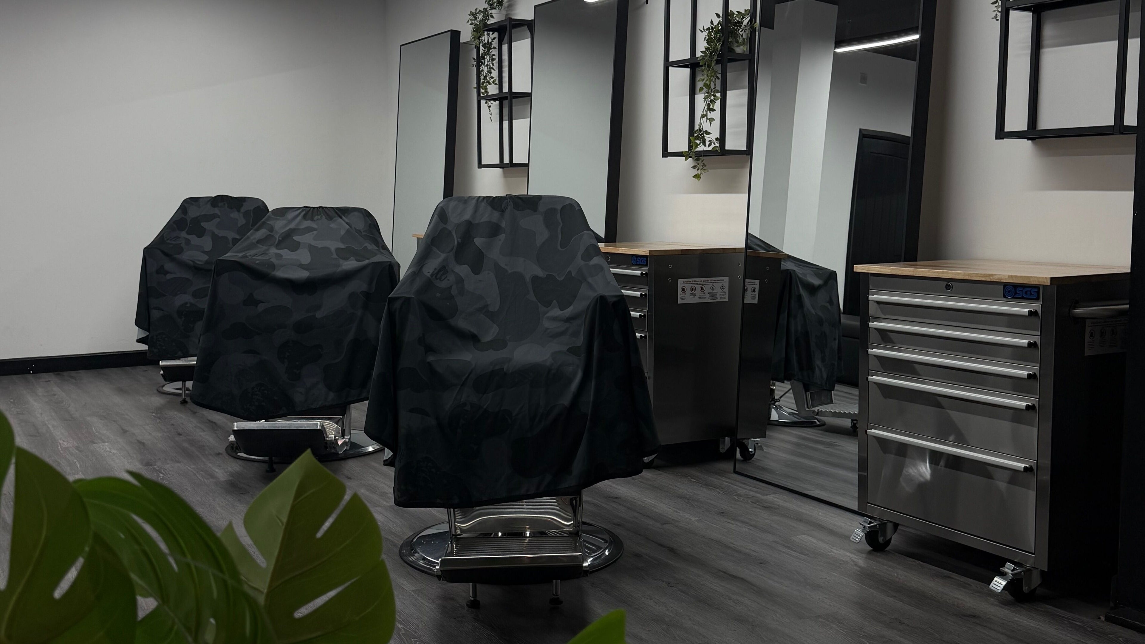 Modern salon chairs with mirrors at Hideout, Glasgow, Scotland, GB. Sleek interior design.