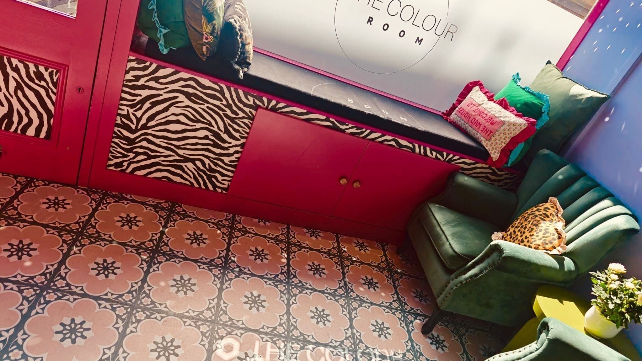 Stylish lounge at The Colour Room in Gloucester, England, GB with vibrant decor and patterned tiles.
