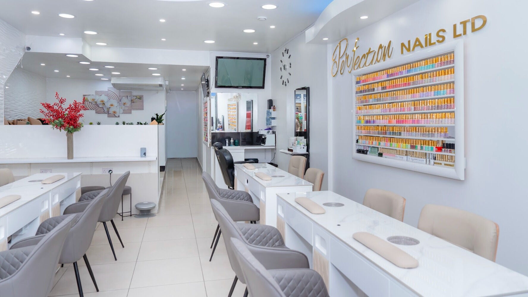 Chic interior of Perfection Nail salon in London, England, GB showcasing stylish decor and a wide range of polishes.