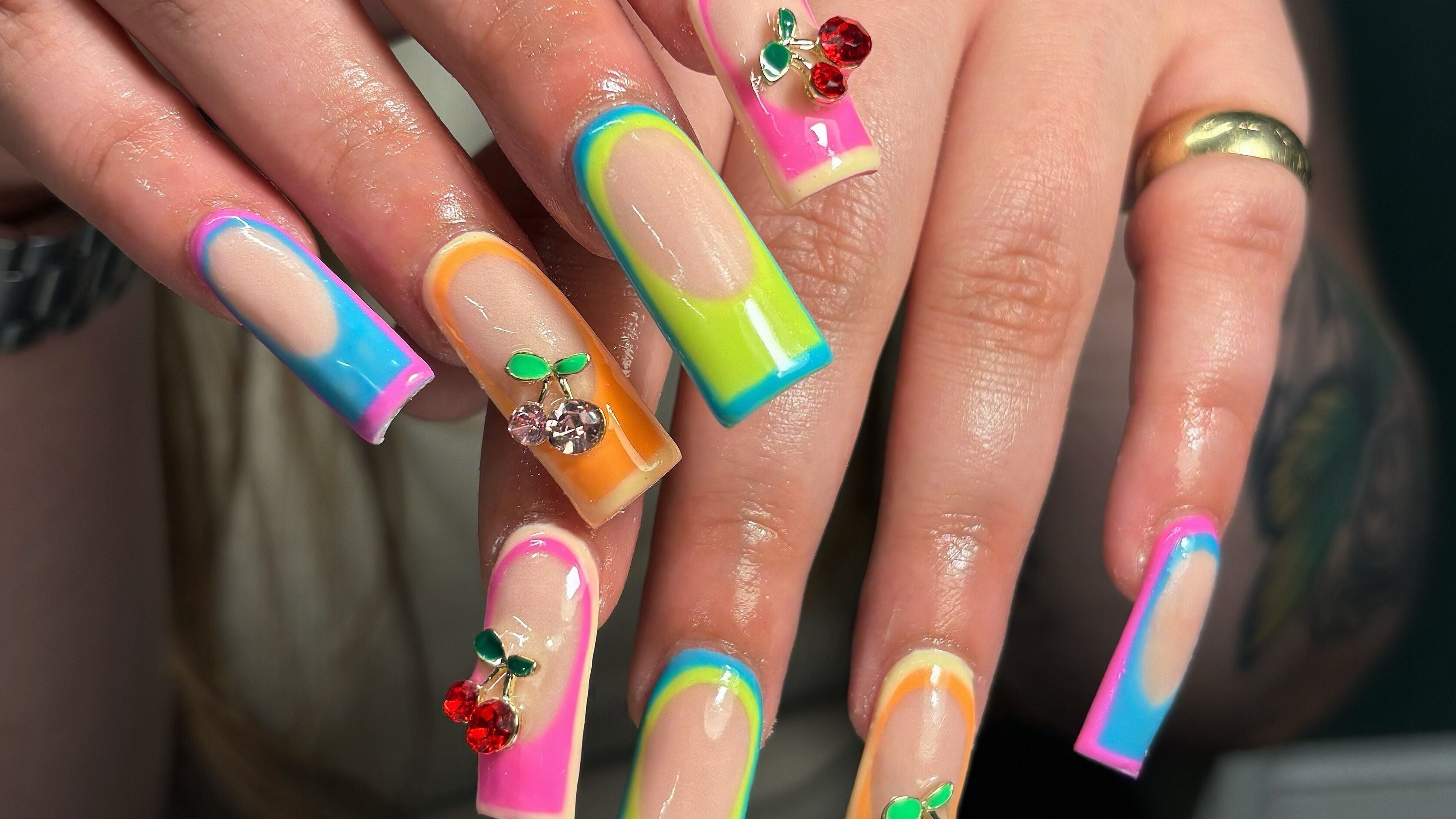 Colorful nail art with gem accents at Hacrylicz, Seaton Delaval, England, GB. A vibrant manicure showcase.