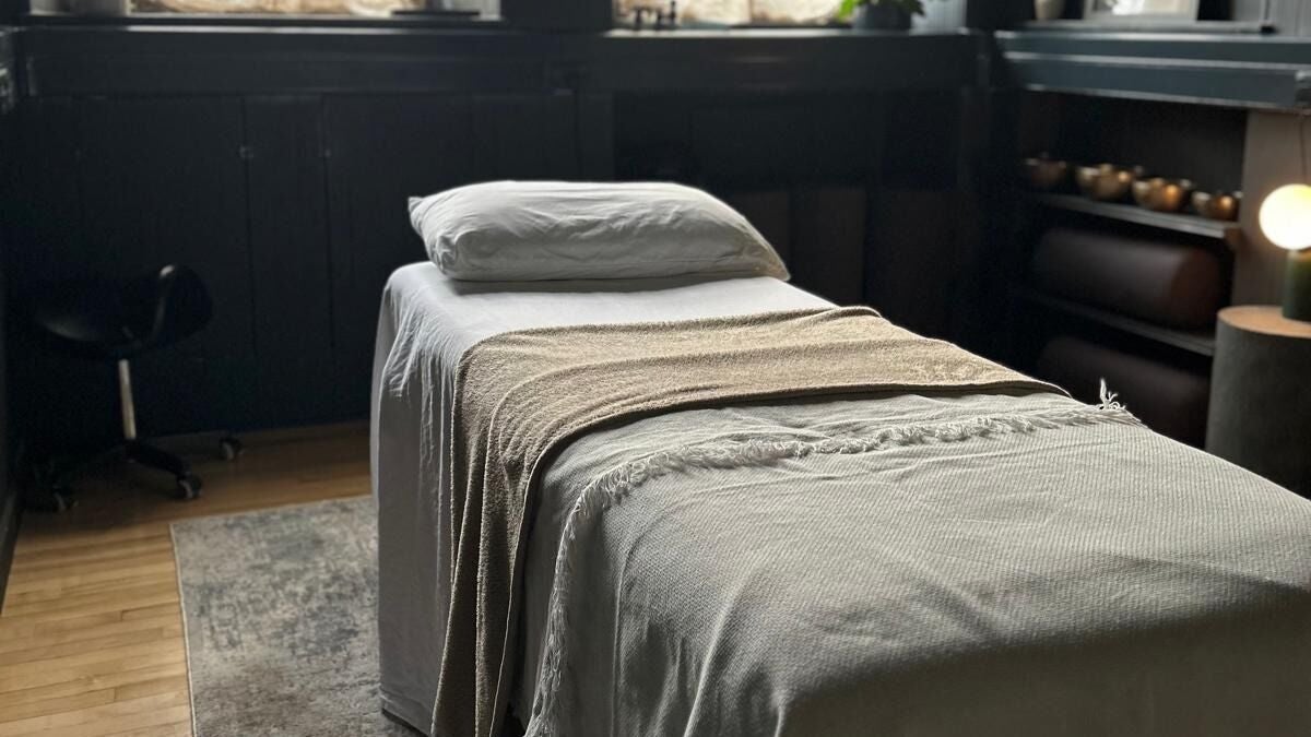 Serene massage room at Purl Massage Therapy in Glasgow, Scotland, GB, featuring a cozy treatment bed.