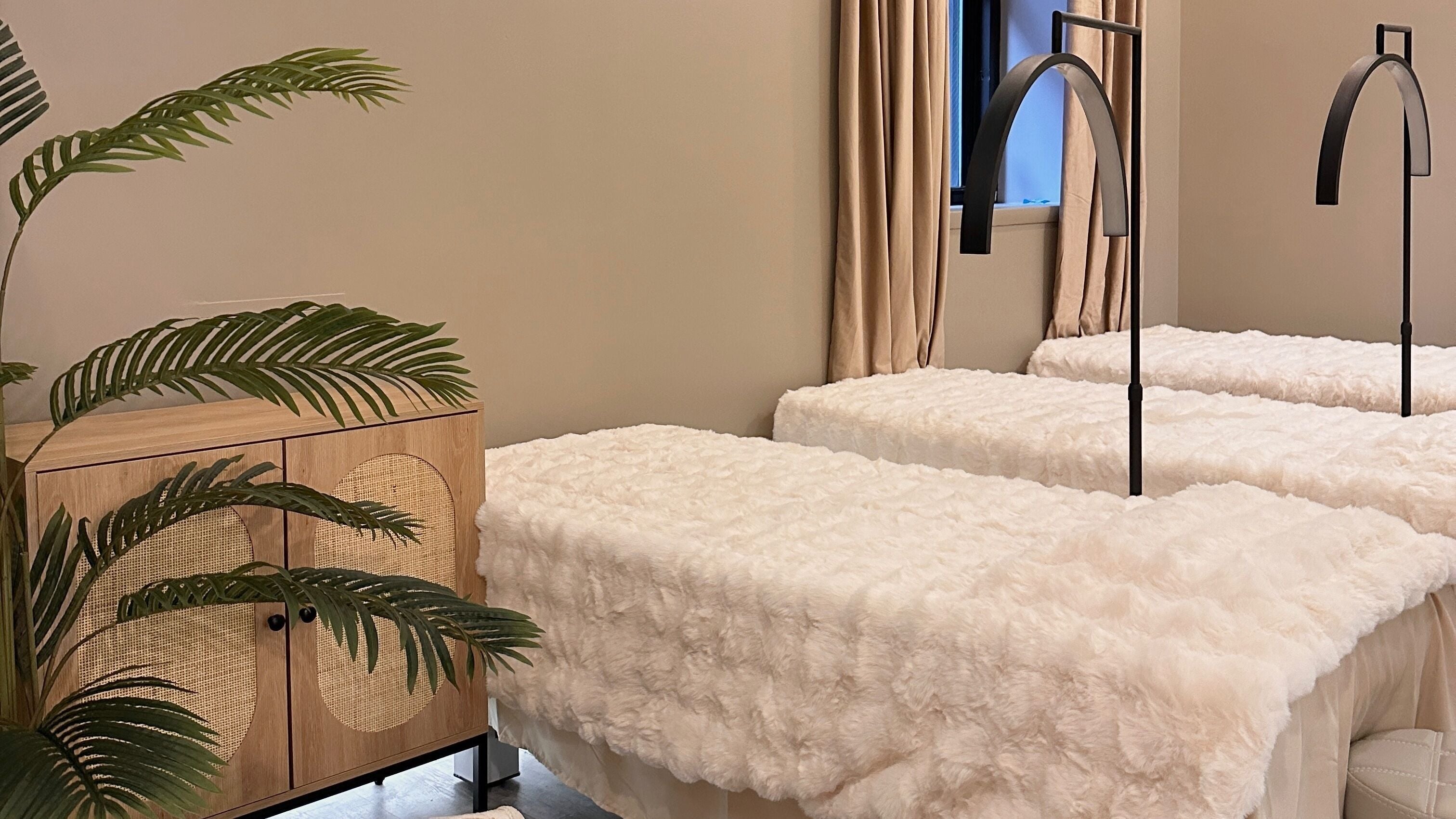 Luxurious treatment beds at HELA Skincare- Midtown, New York, New York, US with plush decor.