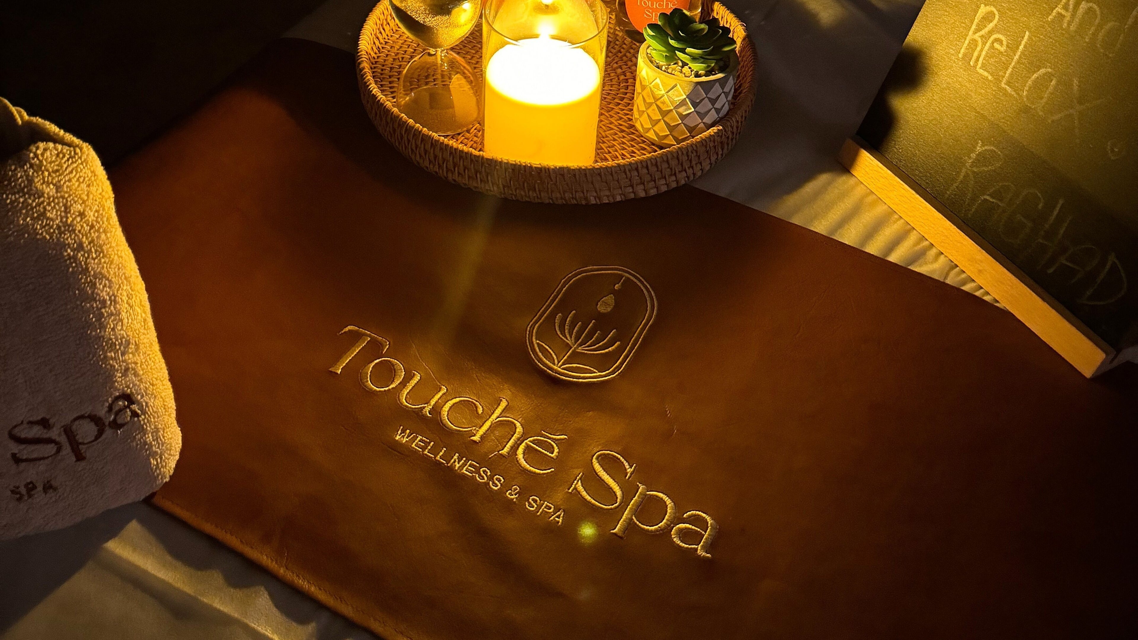 Touché Spa | Home Service ambiance with candle and towel in Jeddah, Makkah Province, SA.