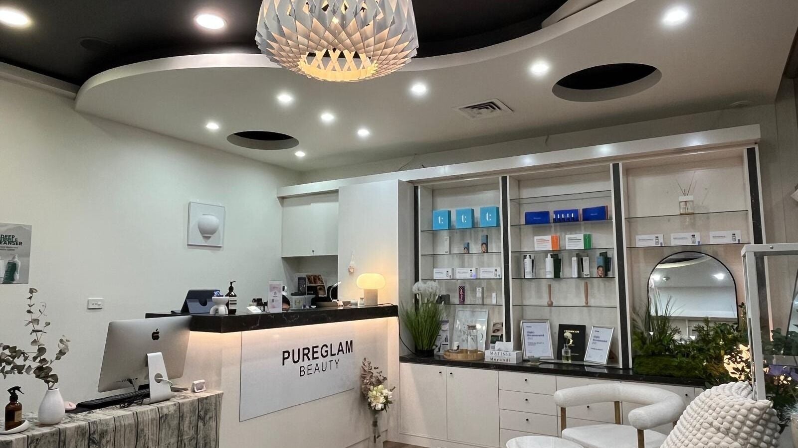 Inside PUREGLAM BEAUTY in Melbourne, Victoria, AU, featuring chic decor and beauty products on display.