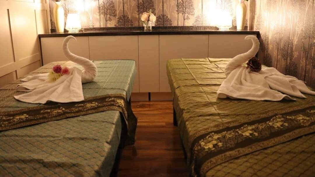 Tranquil treatment room at Baan Thai Wellness And Spa, Huntingdon, England, GB, with elegant decor and swan towels.