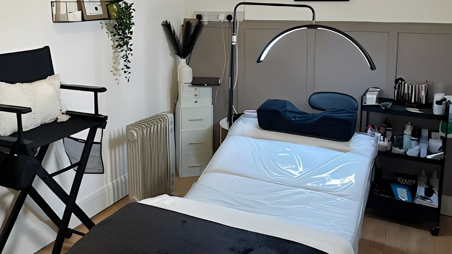 Treatment room at Charlchapman Beauty Studios in Redditch, England, GB, featuring a massage table and cozy decor.