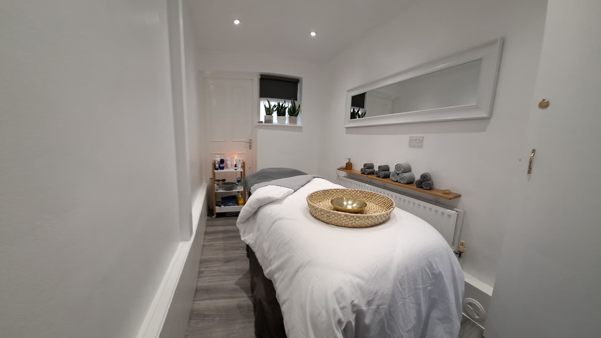 Tranquil treatment room at My Face Spa in Clapham Junction, England, GB with cozy massage bed and ambient lighting.