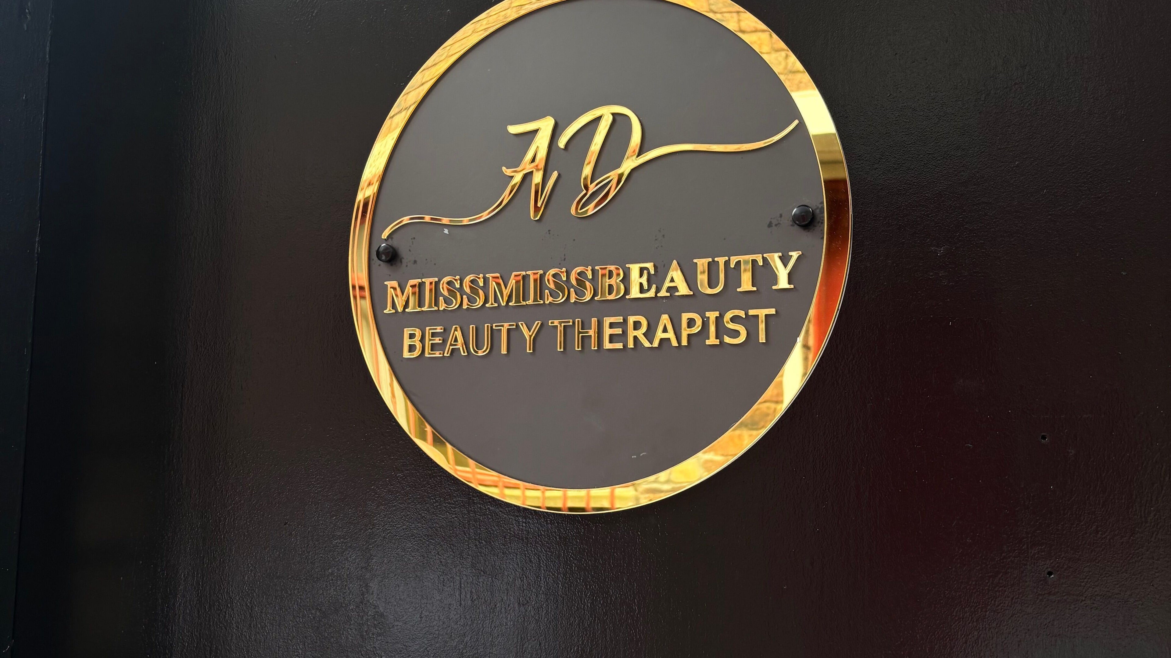 Elegant gold sign at Miss Miss Beauty, Cambuslang, Scotland, GB. Beauty therapist logo display.