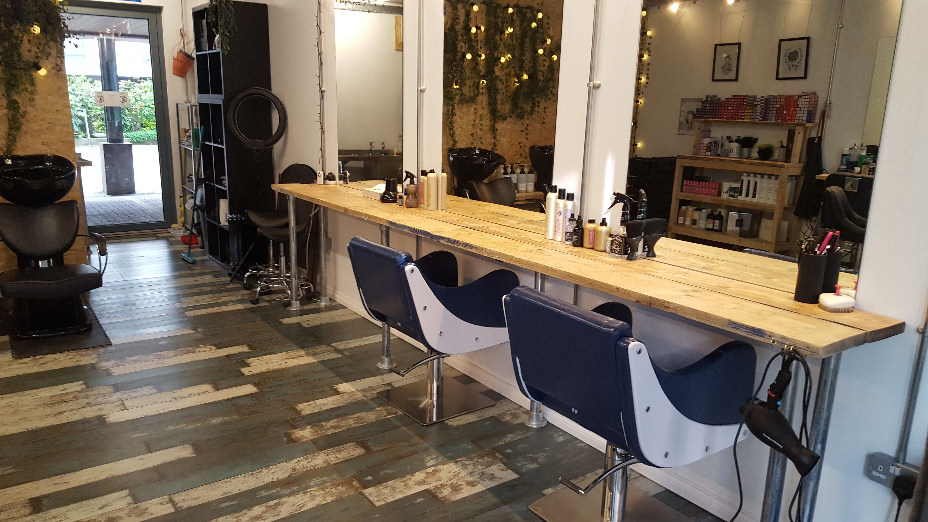 Interior of Harber Hair salon in London, England, GB, featuring stylish chairs and a well-lit mirror setup.