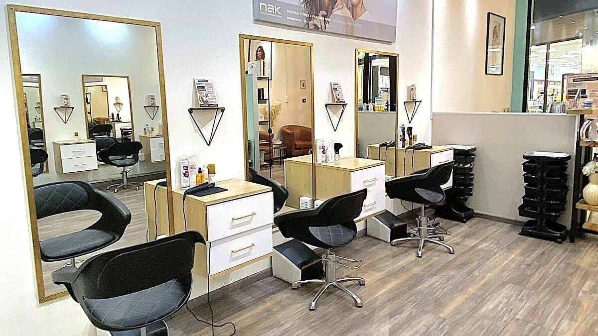 Stylish hair salon interior at Jem 3-Arts Village, Cape Town, Western Cape, ZA with mirrors and salon chairs.