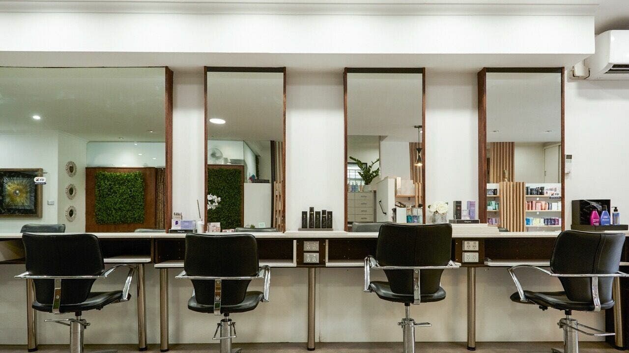 Modern salon interior at Second Avenue Hair and Beauty Camberwell, Melbourne, Victoria, AU with black chairs.