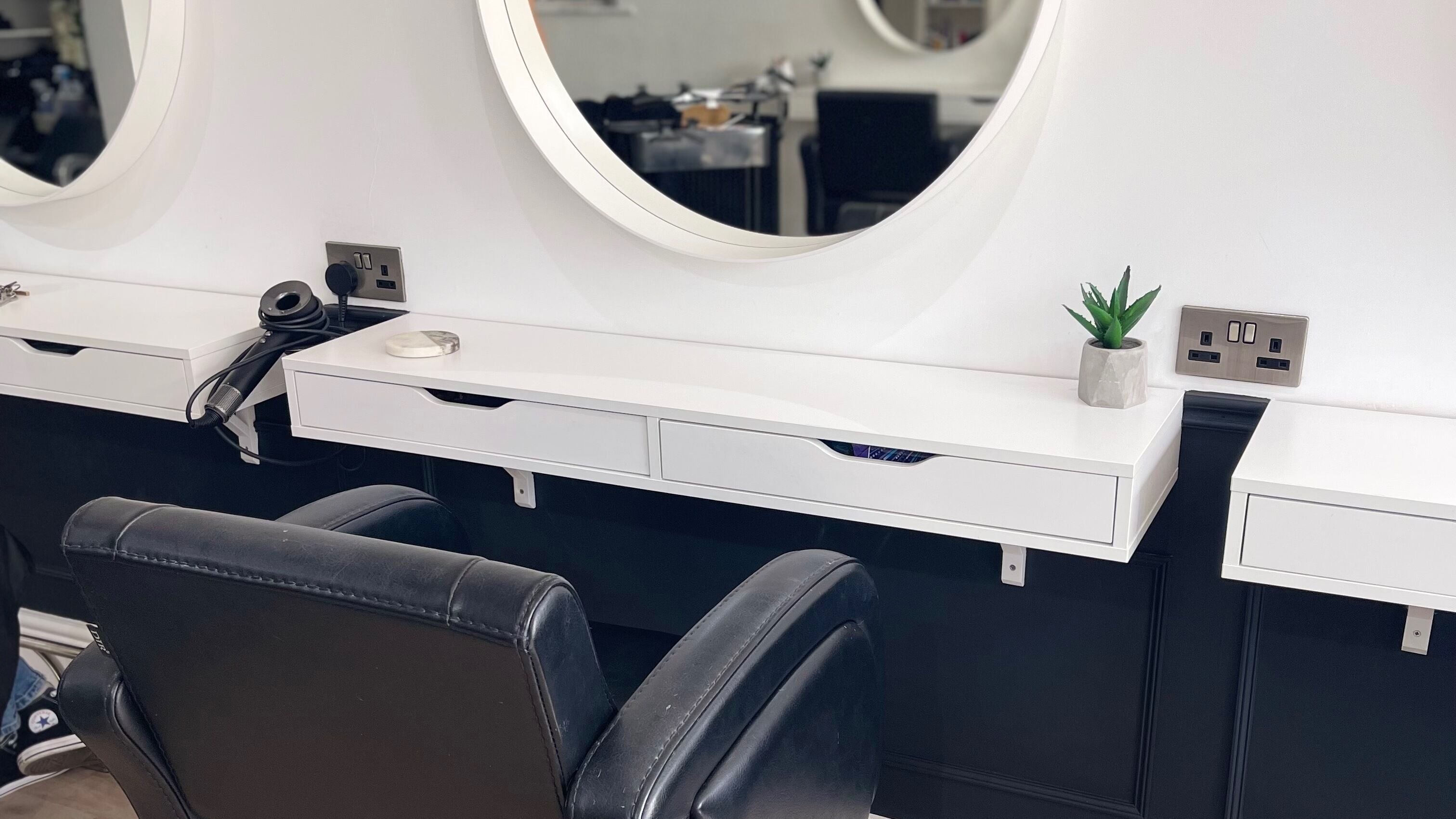 Elegant styling station at Hair With Jess, Burton Upon Trent, England, GB, featuring a sleek mirror and chair.