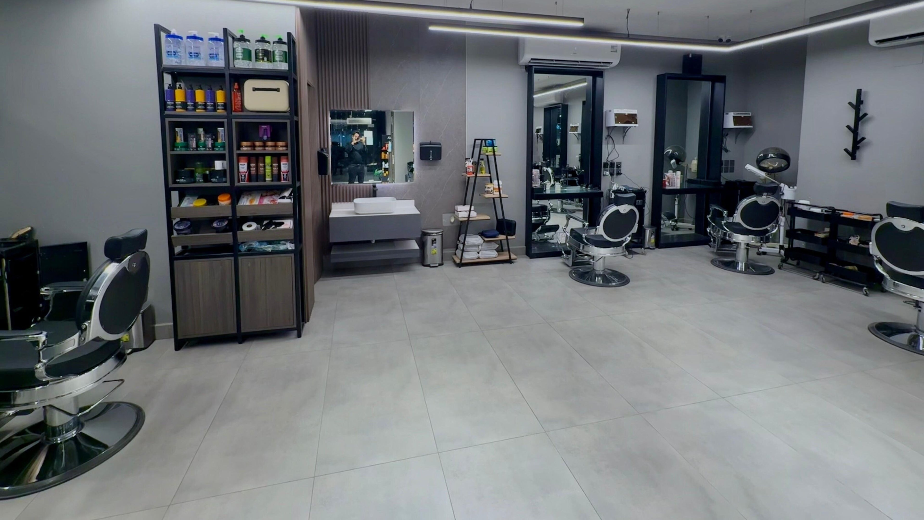 Modern interior of The Address Barber | صالون العنوان الغدير in Riyadh, Riyadh Province, SA with sleek chairs.