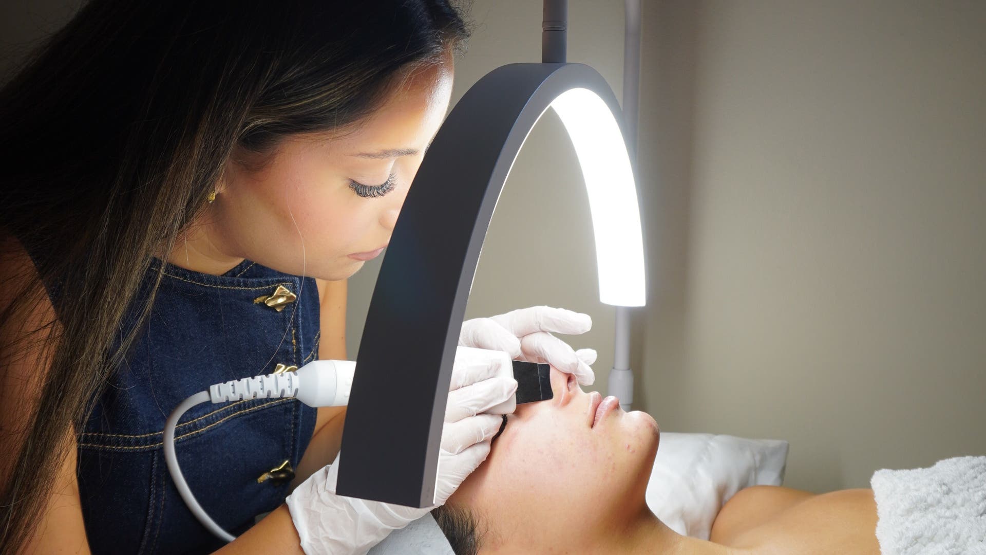 Skincare treatment session at Liv With Beauty, Melbourne, Victoria, AU with expert esthetician under soft lighting.