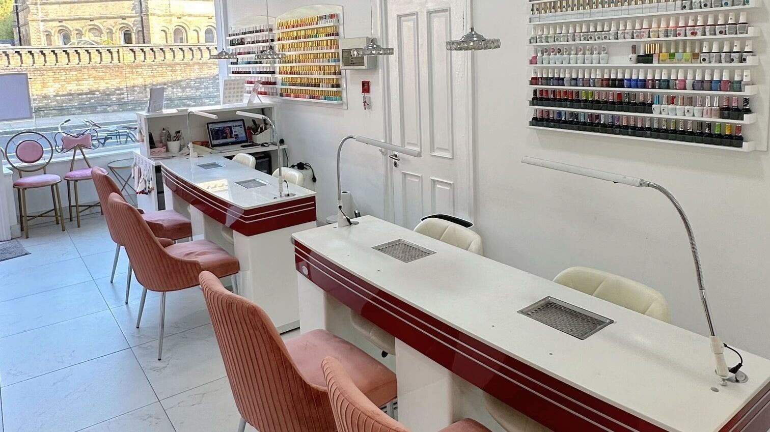 Trendy interior of Le Feu Nails in London, England, GB featuring stylish nail stations and colorful polish display.