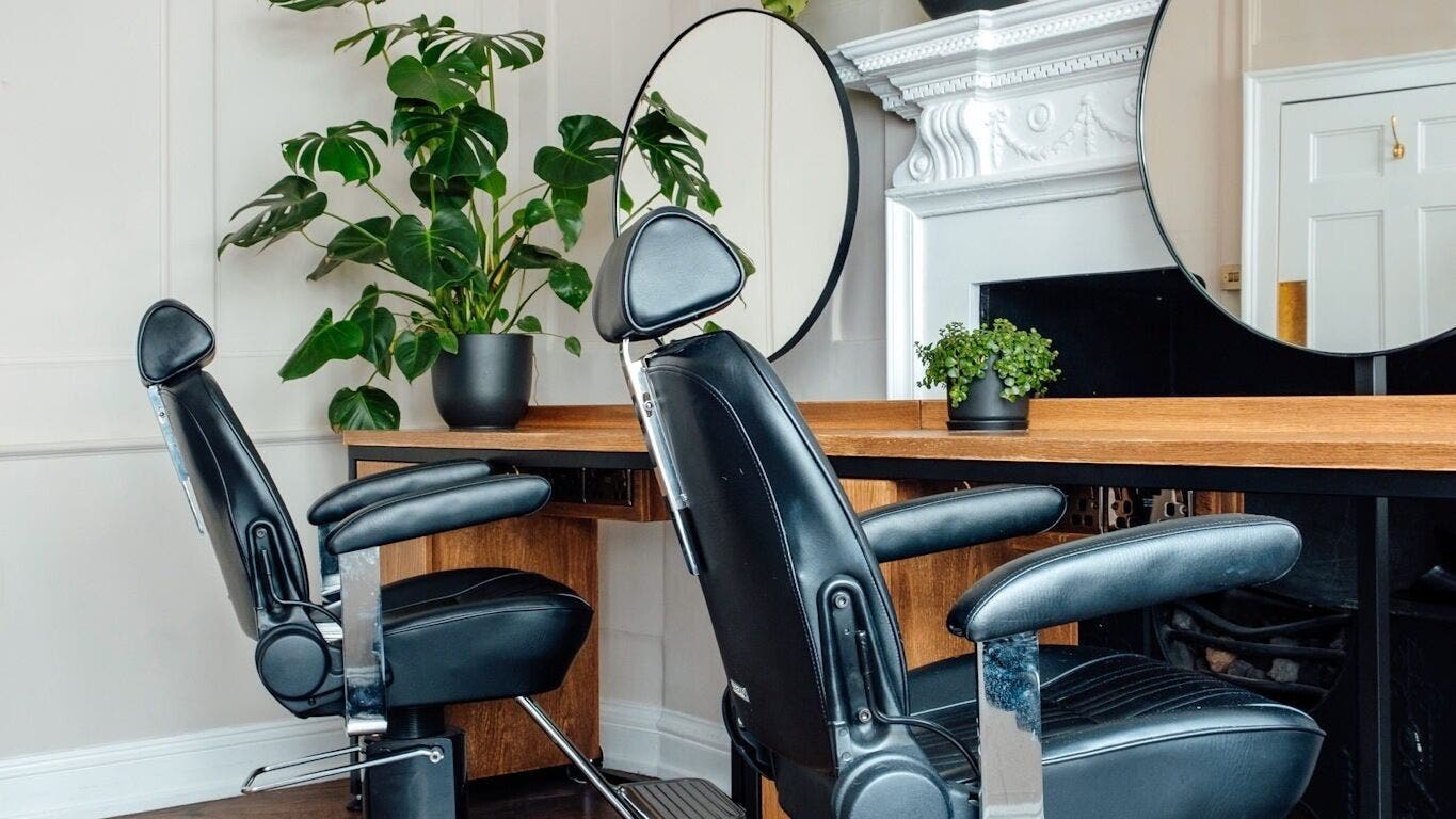 Modern styling chairs at Thea Hair Rendezvous, London, England, GB, enhancing elegance and comfort.