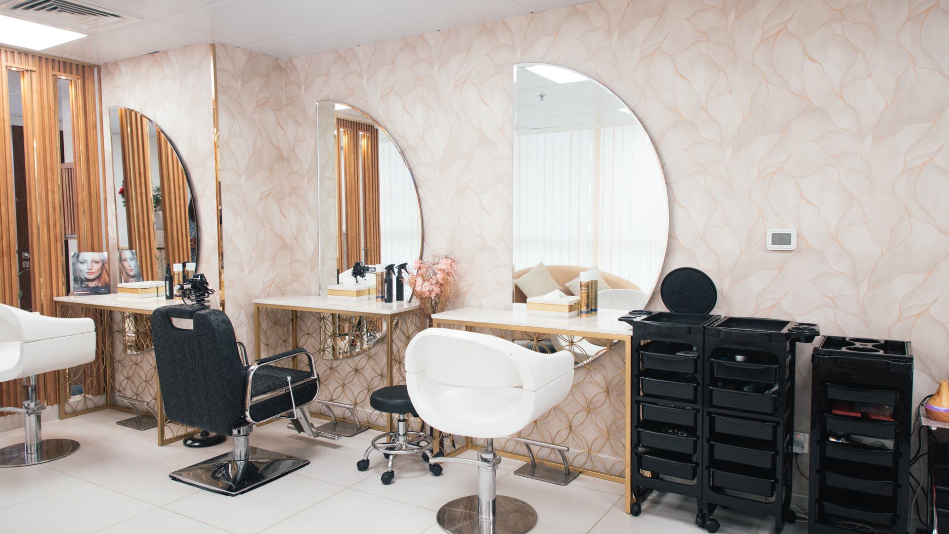 Chic styling stations with large mirrors at Curly Sue Beauty Lounge, Abu Dhabi, Abu Dhabi, AE.