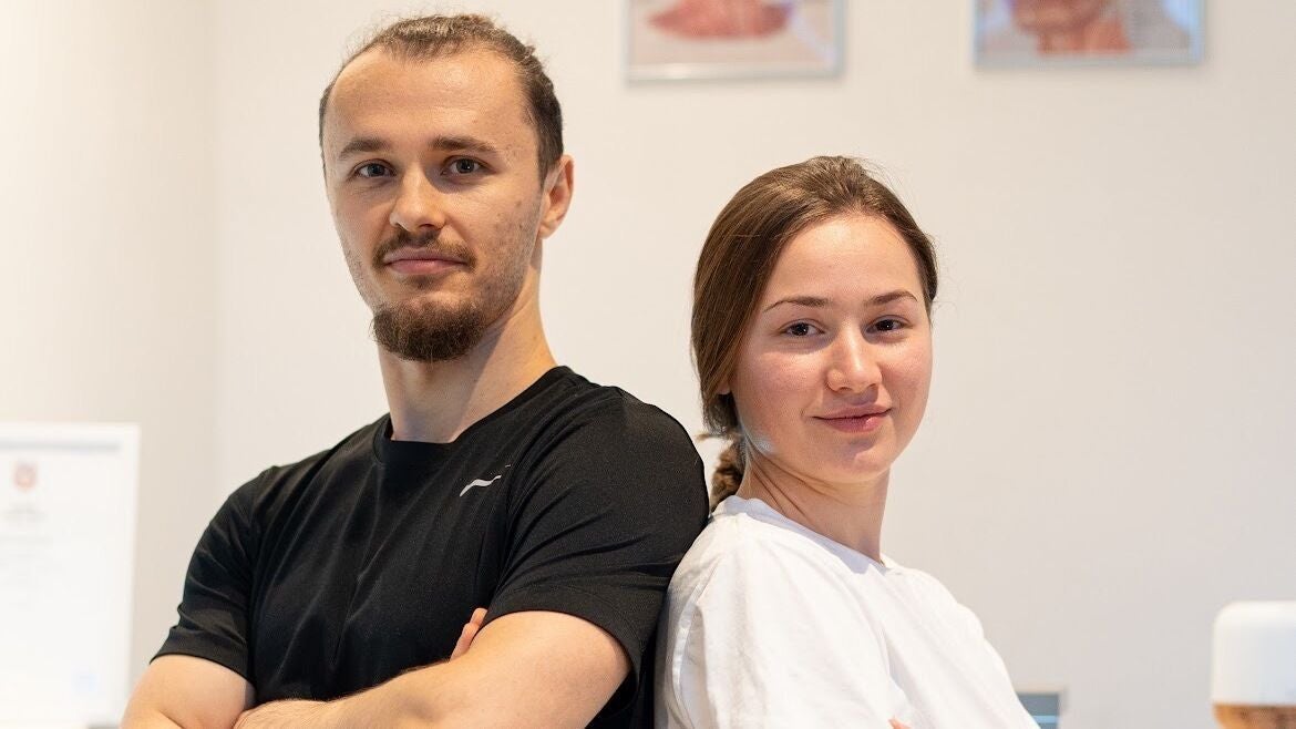 Massage therapists at MG Massage Therapy, London, England, GB, standing confidently together.