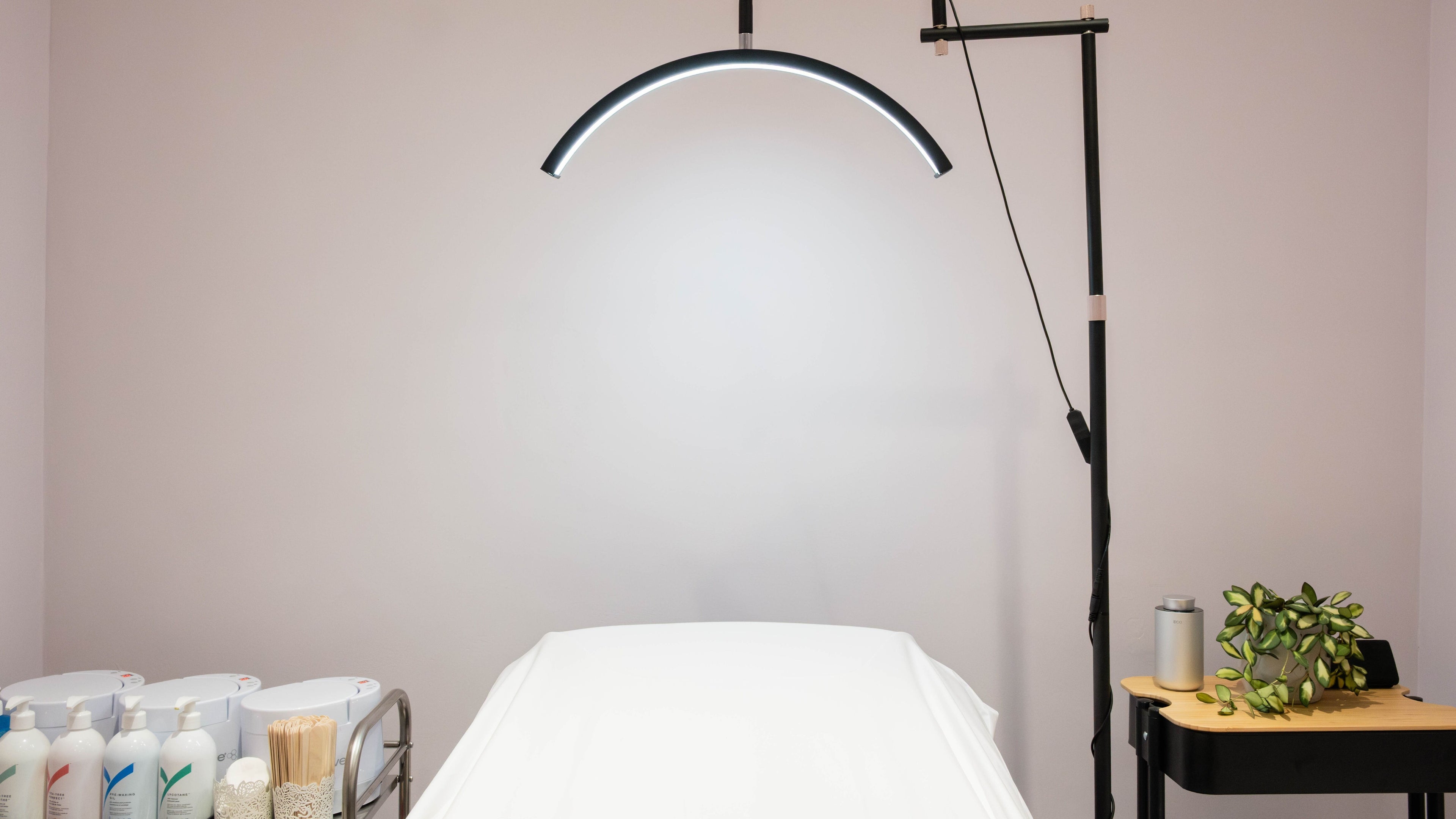 Gloss Polish / Juliana spa room in London, England, GB, featuring a treatment bed and stylish decor.