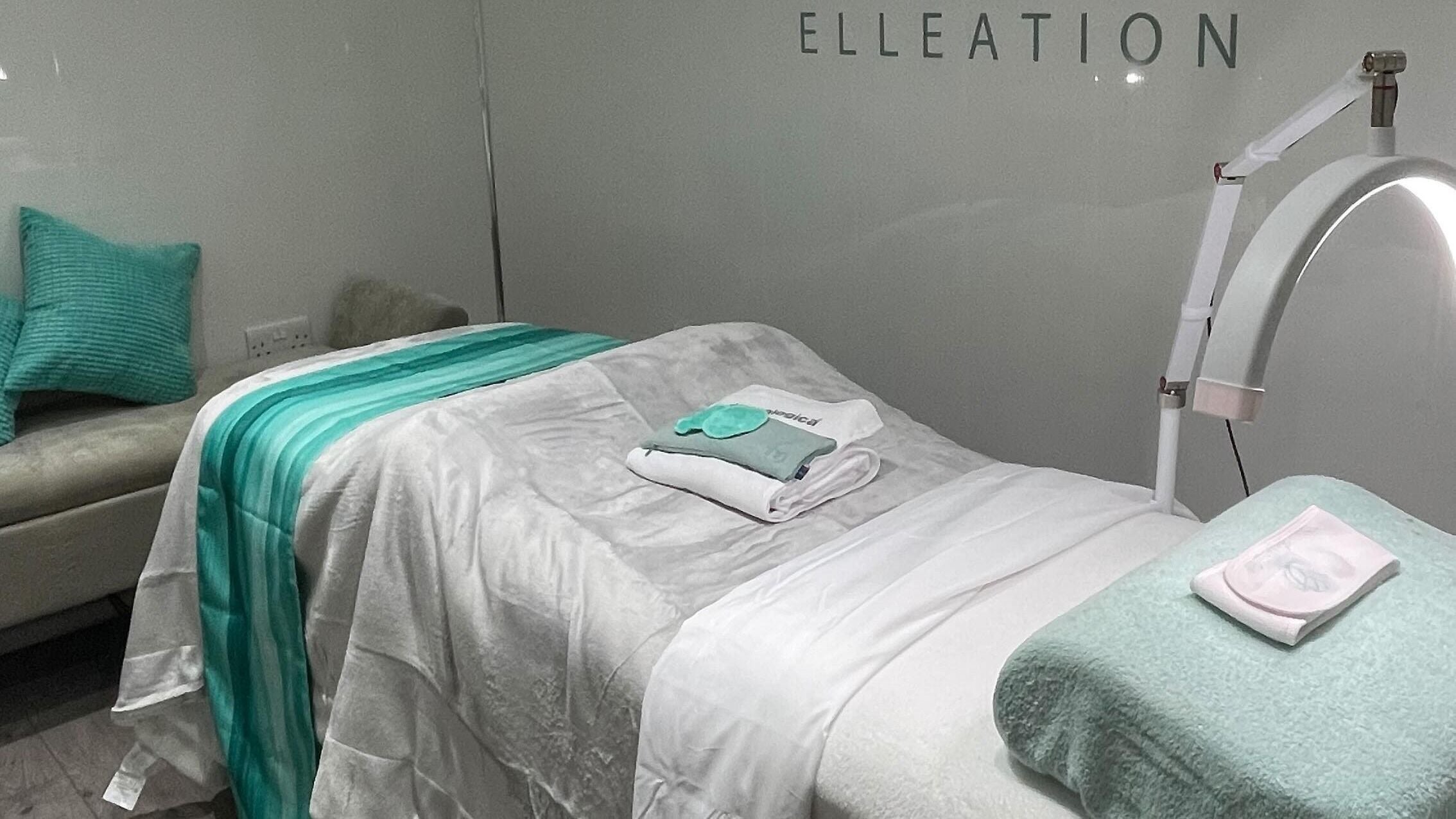 Relaxing treatment room at Facial Elleation, Banstead, England, GB, featuring a cozy bed and soft lighting.