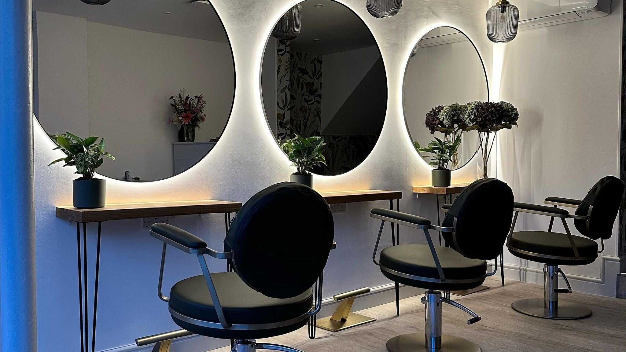 Sleek styling chairs and illuminated mirrors at BOUDICA Hair And Beauty, Mountsorrel, England, GB.