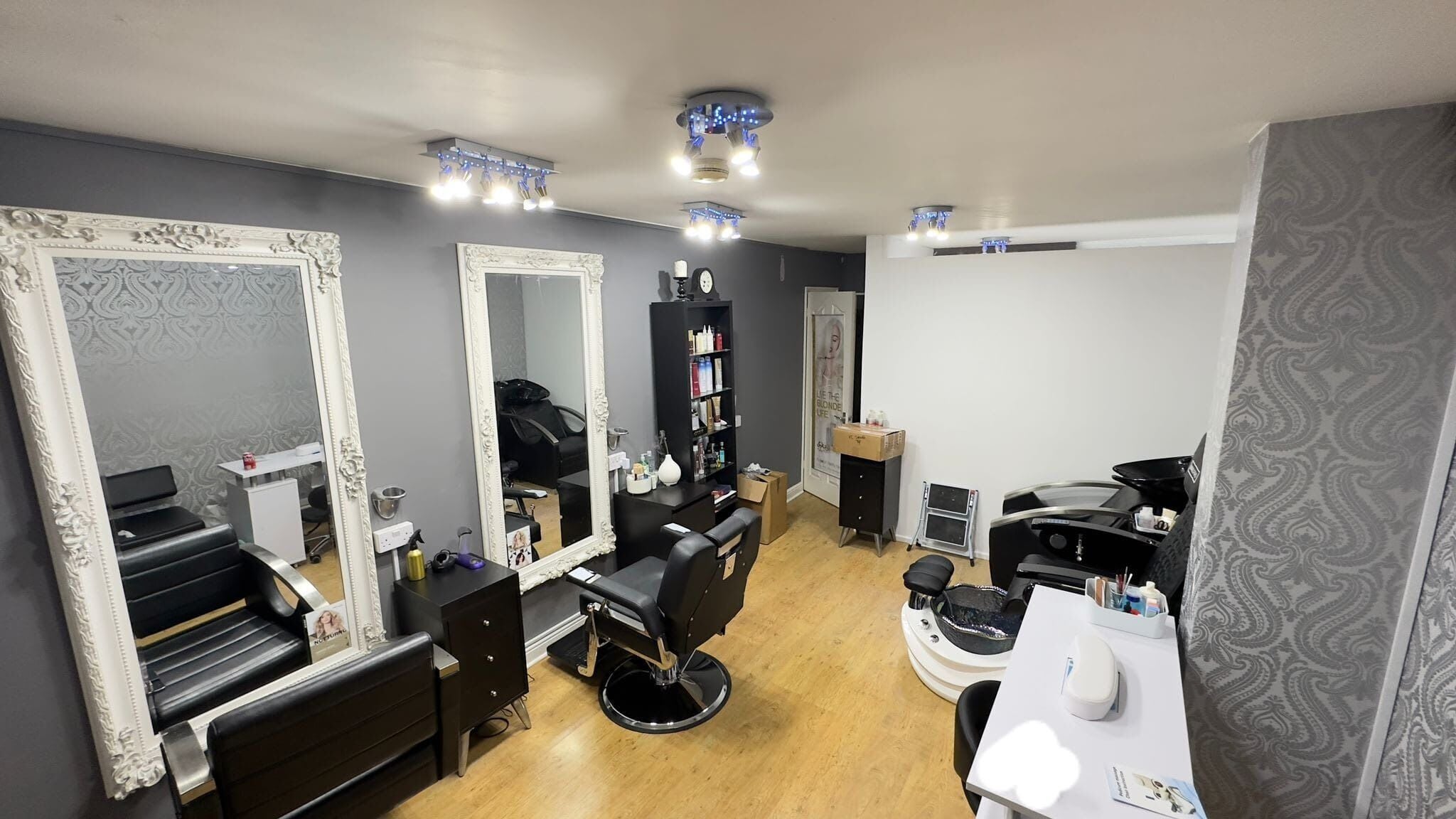 Elegant salon setup at Glow Beauty Works, Dartford, England, GB with stylish mirrors and seating areas.