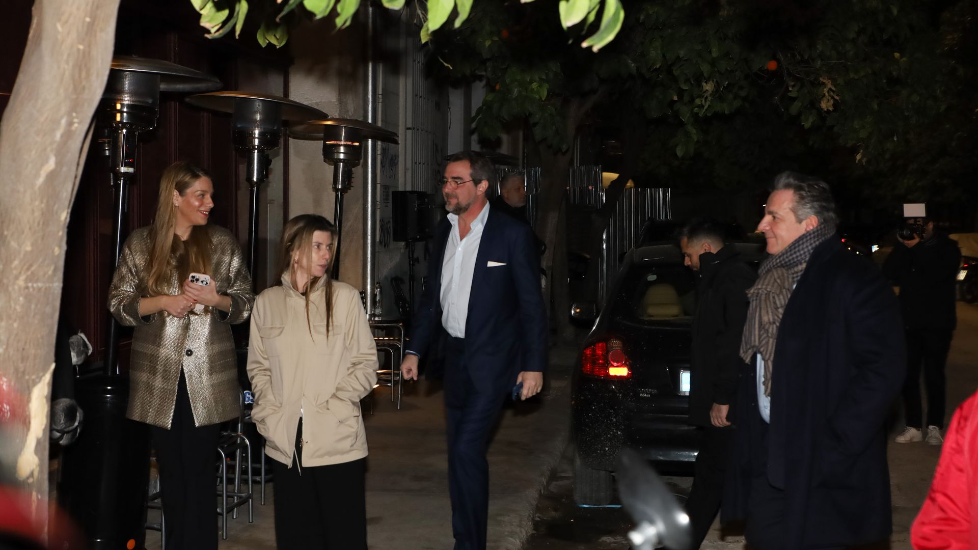 Chrysi Vardinogianni and Prince Nikolaos walking down a street