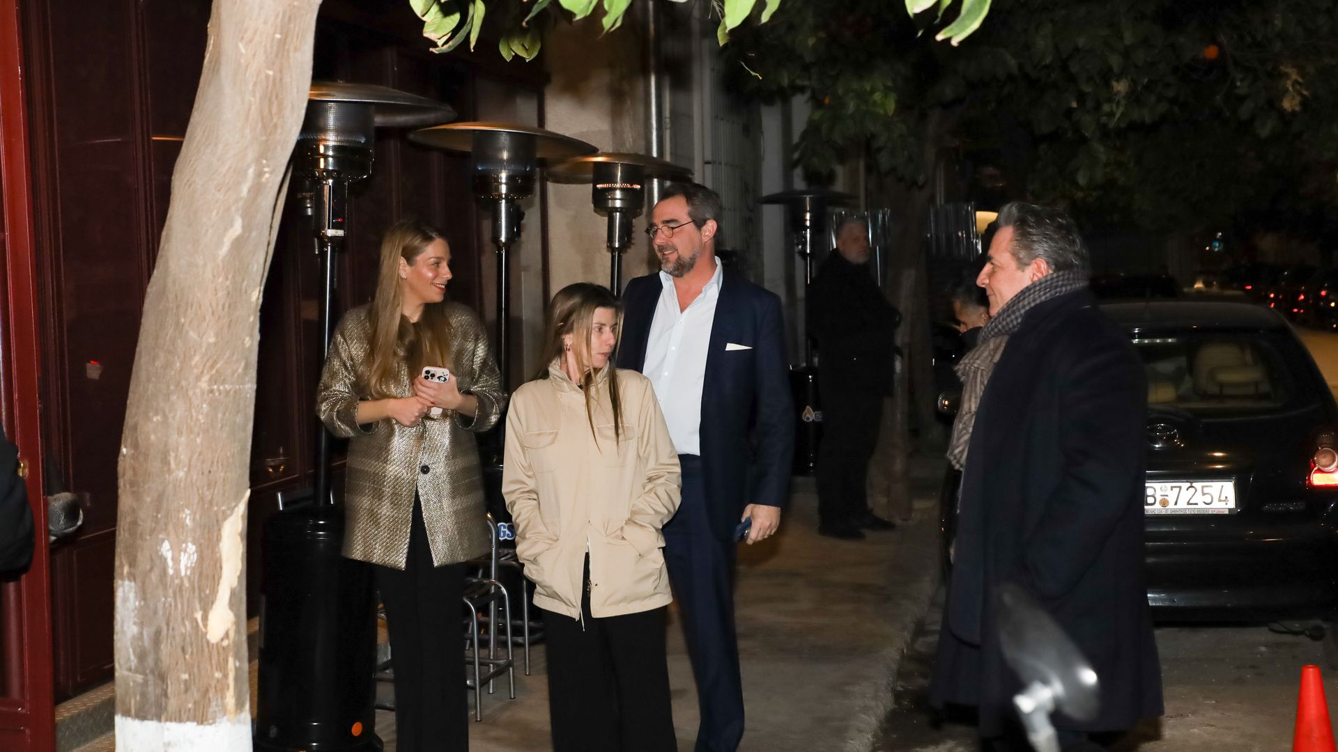 Chrysi Vardinogianni and Prince Nikolaos walking near a restaurant