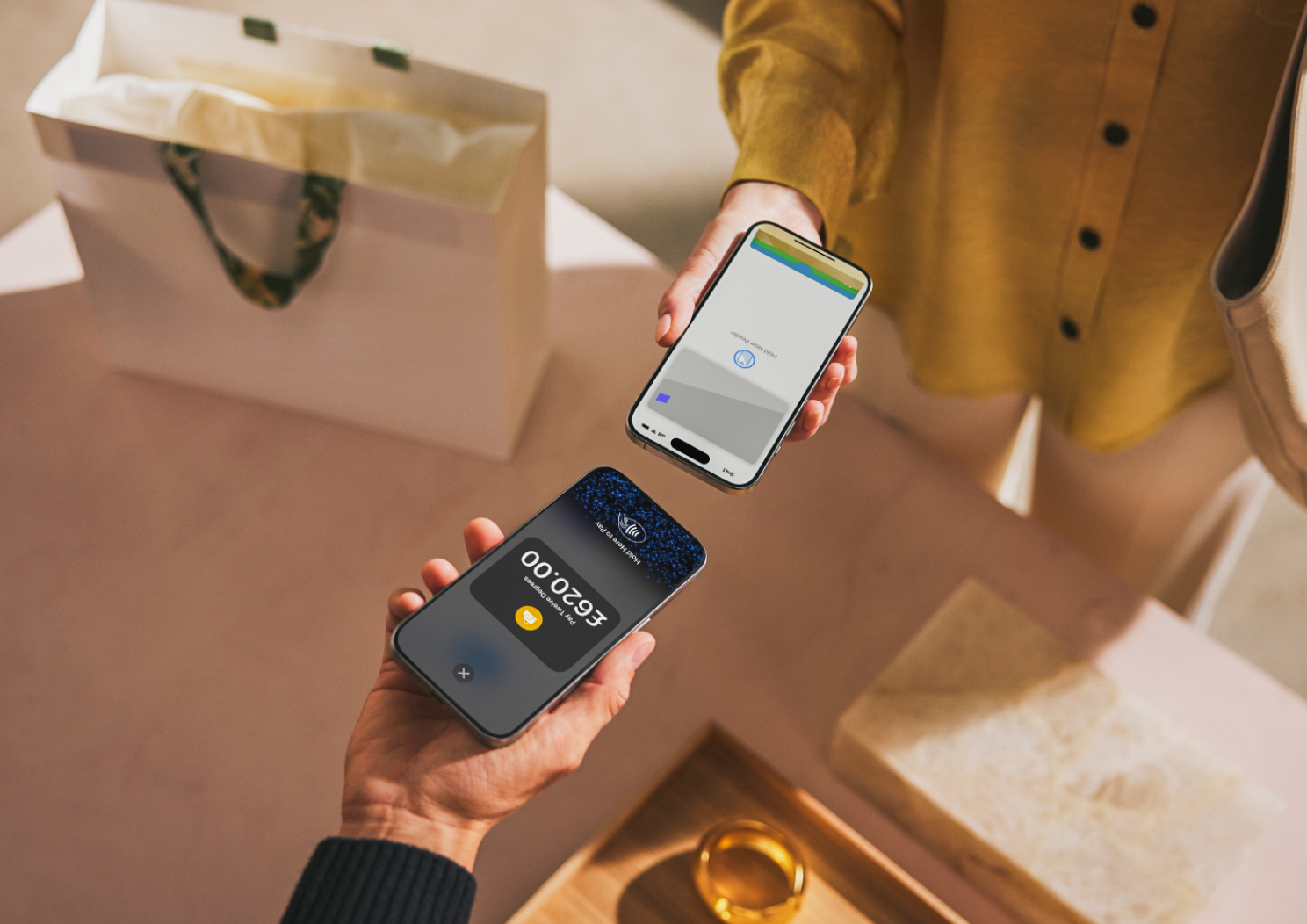 Person using tap to pay to checkout in a retail store.