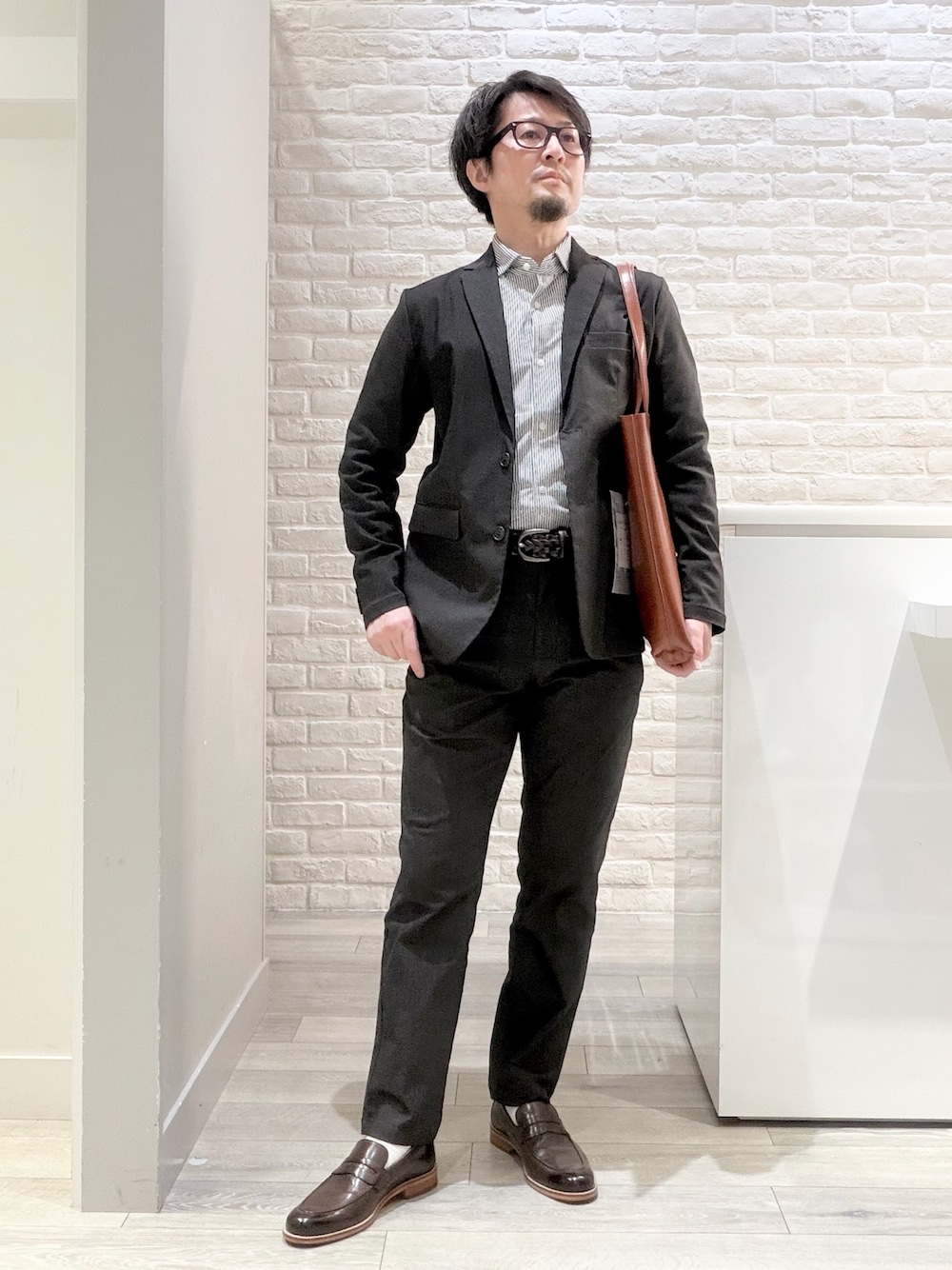 ブラウン系のローファー、イエロー系のトートバッグ、ブルー系のシャツ/ブラウスを着用したメンズの春コーディネートの1枚目の写真