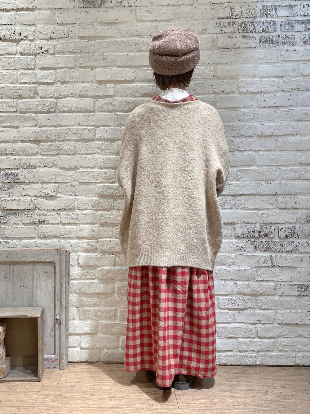 ホワイト系のTシャツ/カットソー、レッド系のシャツワンピース、ベージュ系のカーディガン/ボレロを着用したレディースの冬コーディネートの3枚目の写真