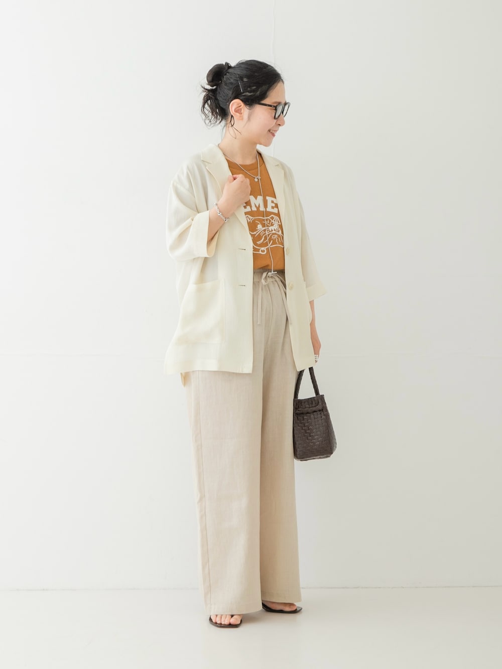 ベージュ系のその他パンツ、ブラウン系のサンダル、ブラウン系のトートバッグを着用したレディースの夏コーディネートの4枚目の写真