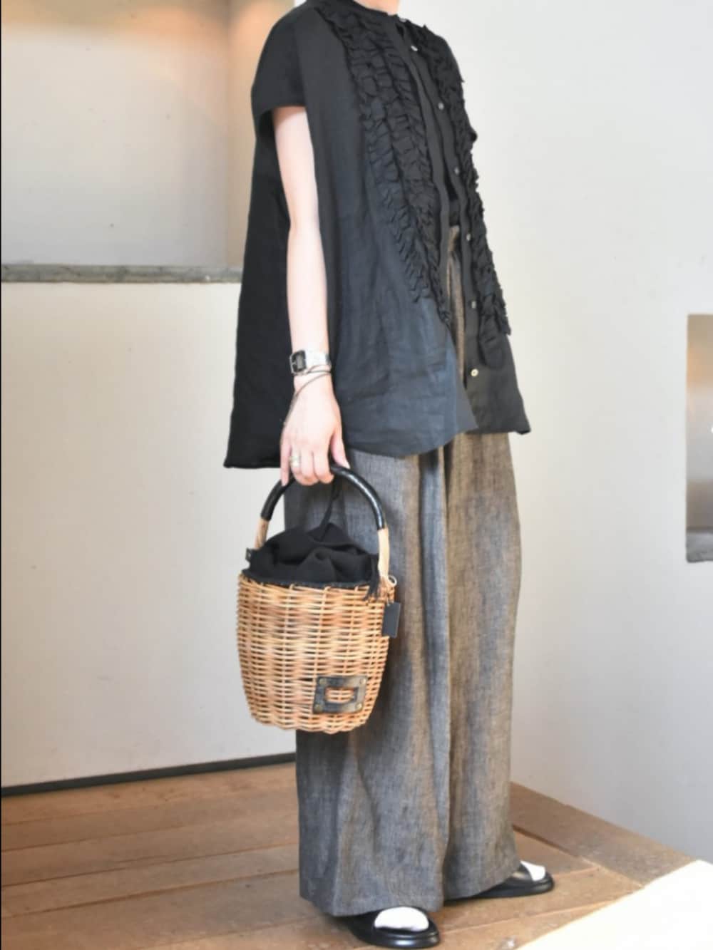 ブラック系のシャツ/ブラウス、ブラック系のTシャツ/カットソー、ブラック系のかごバッグを着用したレディースの春コーディネートの7枚目の写真