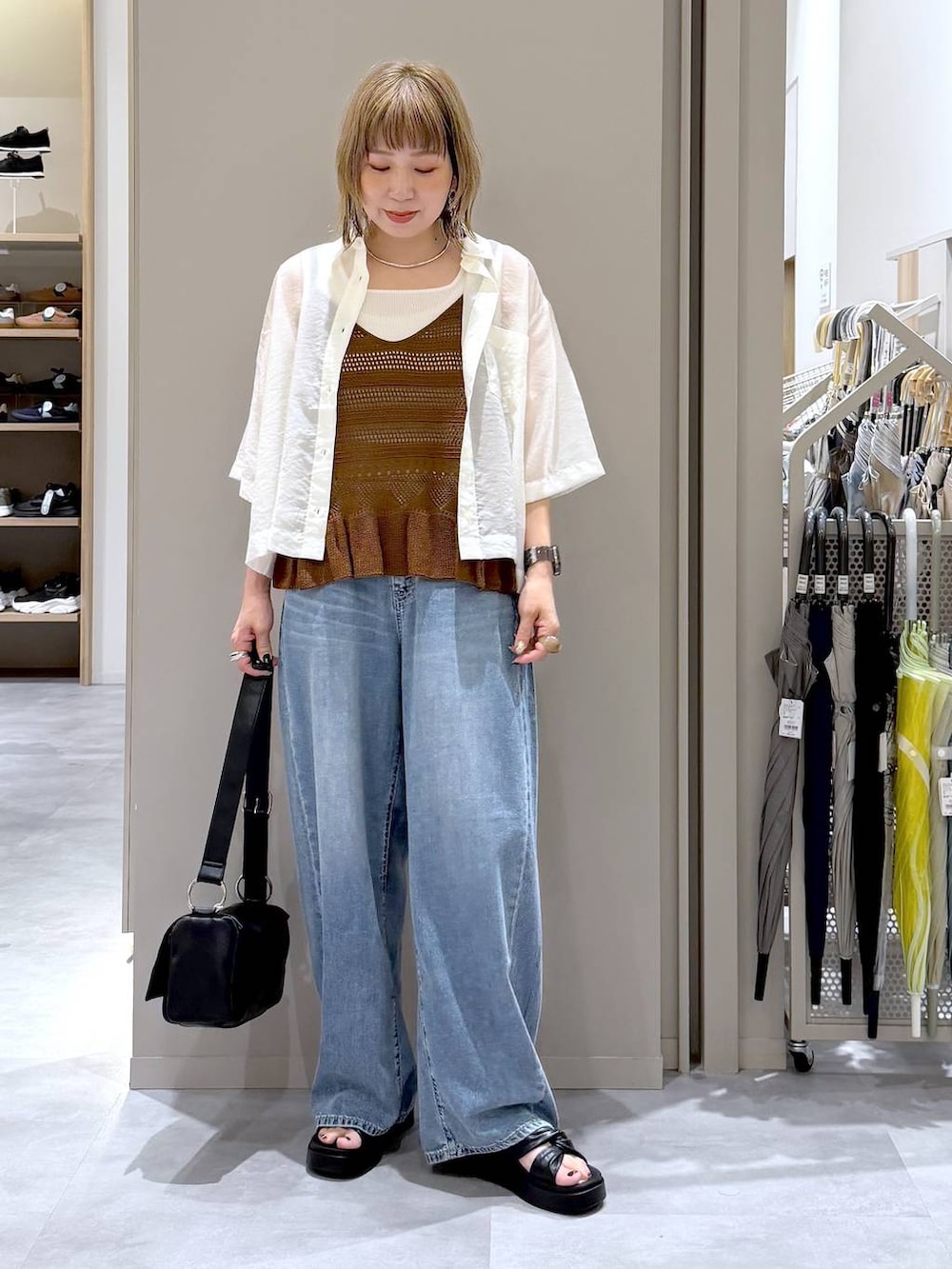 ブルー系のデニムパンツ、ホワイト系のシャツ/ブラウス、ホワイト系のタンクトップを着用したレディースの夏コーディネートの4枚目の写真