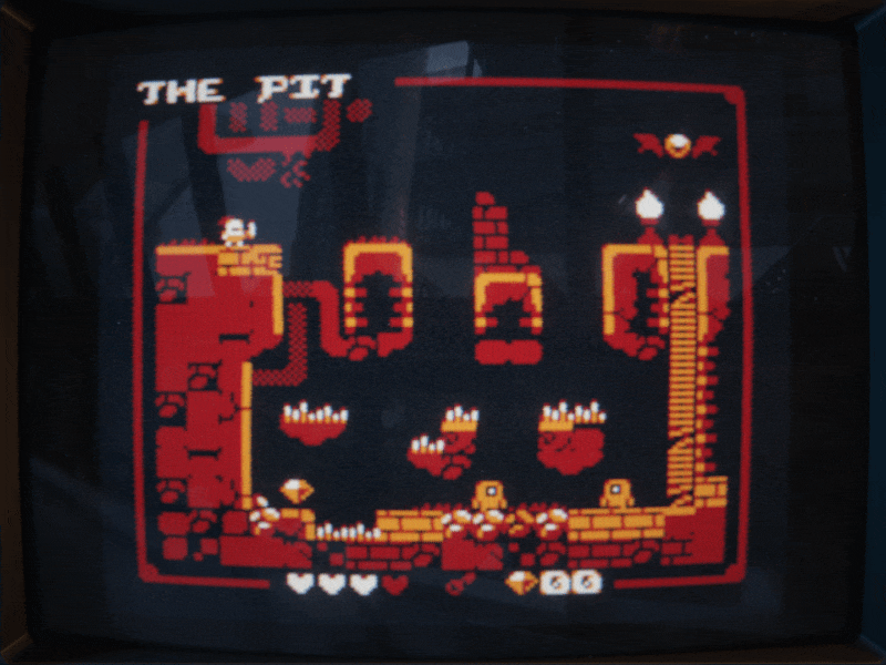 THE PIT Retro platformer game screen with a character, platforms, spikes, gems, and the level title 'THE PIT' at the top.