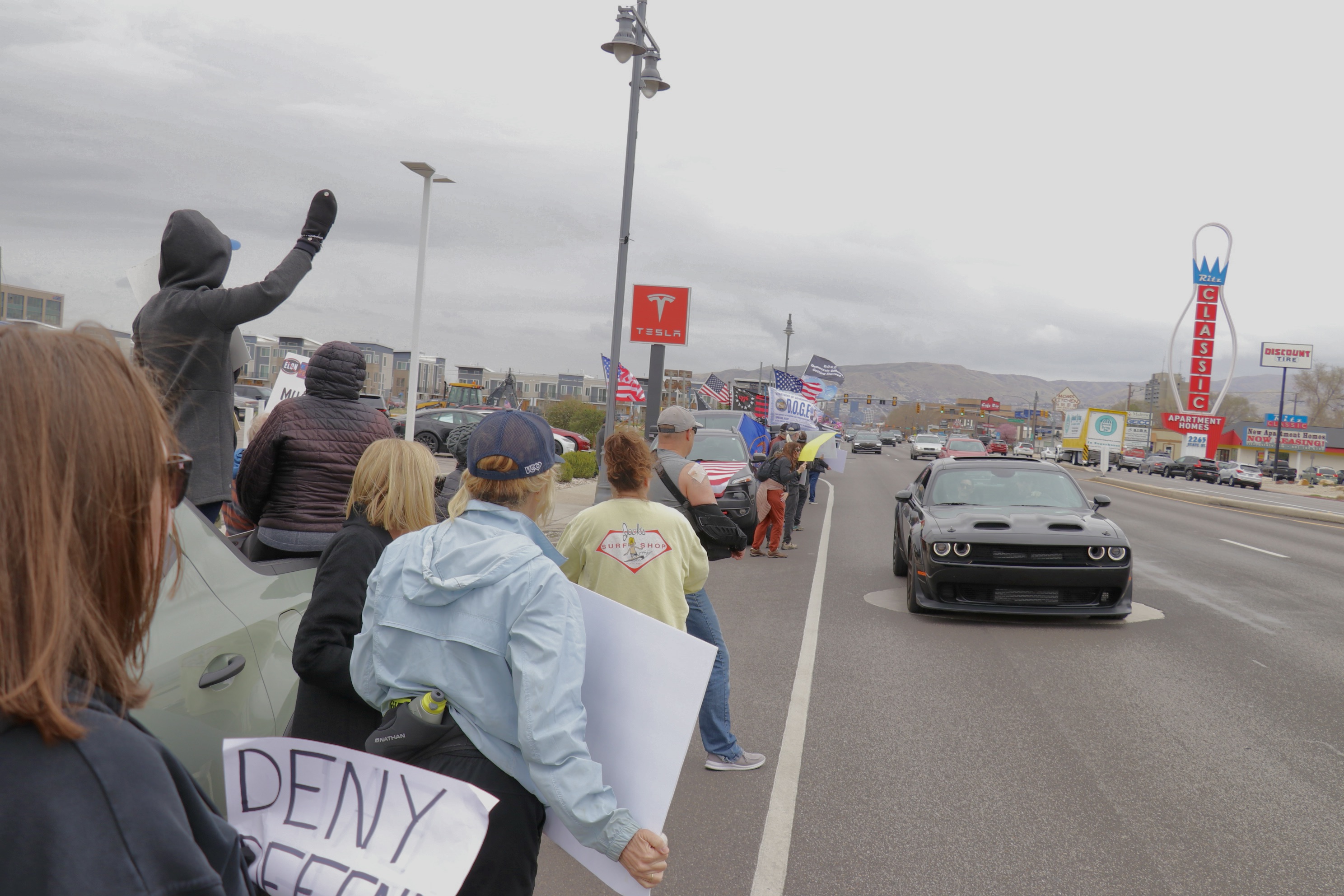 Dueling demonstration groups converge on a Tesla dealership in South Salt Lake