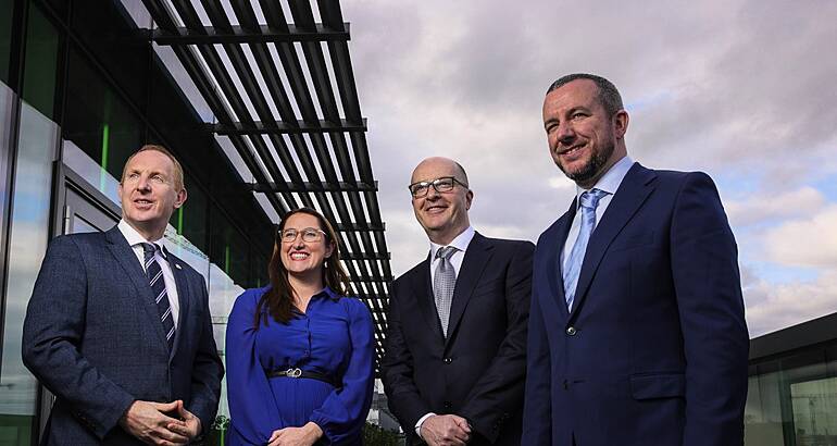 From left: Michael Lohan, CEO, IDA Ireland; Minister of State Emer Higgins, TD; Tom Clarke, West; and Simon Frainey, West, all posing outside a building with a grey sky in the background.