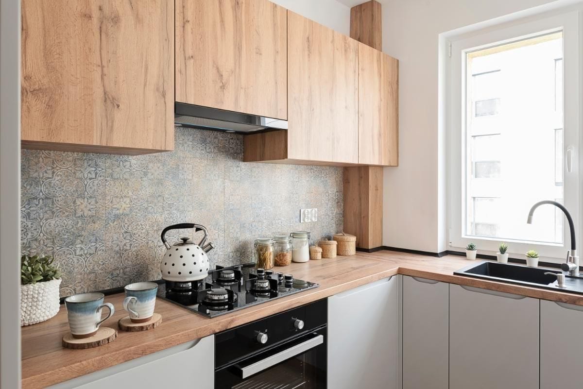 Wooden kitchen cabinet design with sink near window