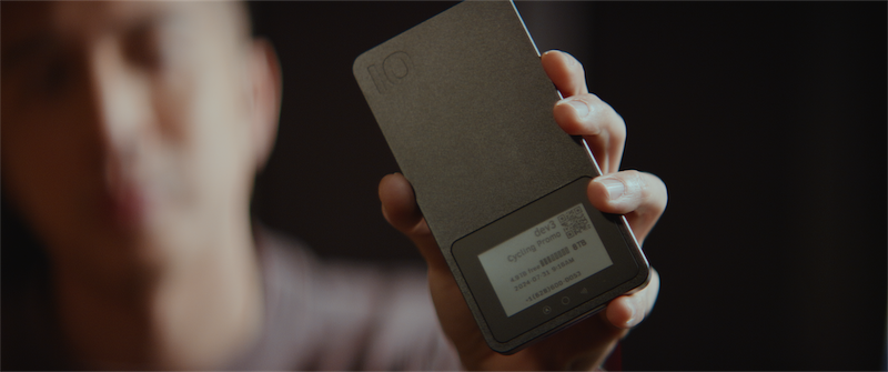 Pro Mini portable SSD held by a user, showcasing its sleek design and digital label, highlighting advanced security and tracking features for professional creatives.